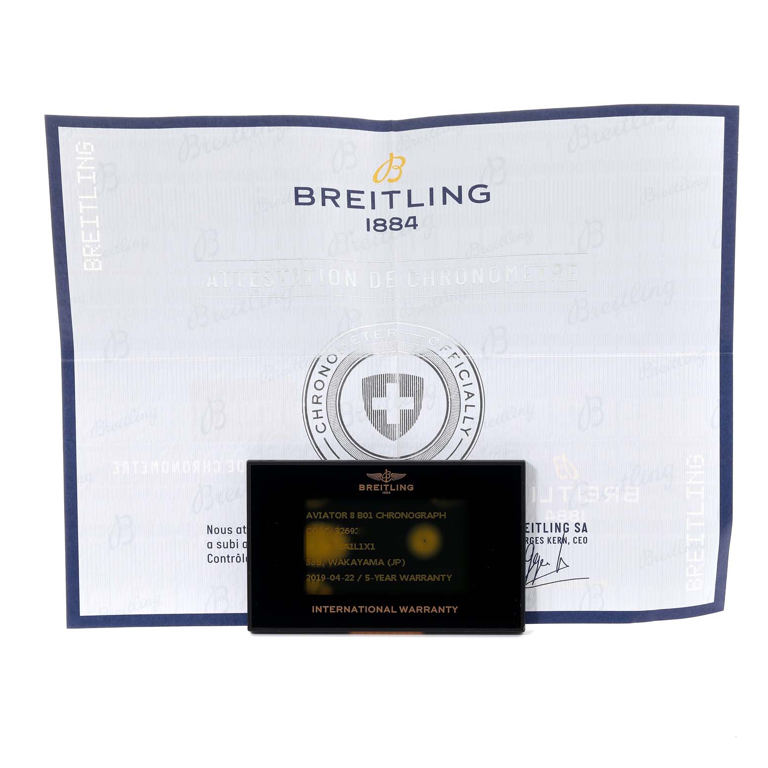 The image shows the warranty card and documentation for a Breitling Navitimer watch.