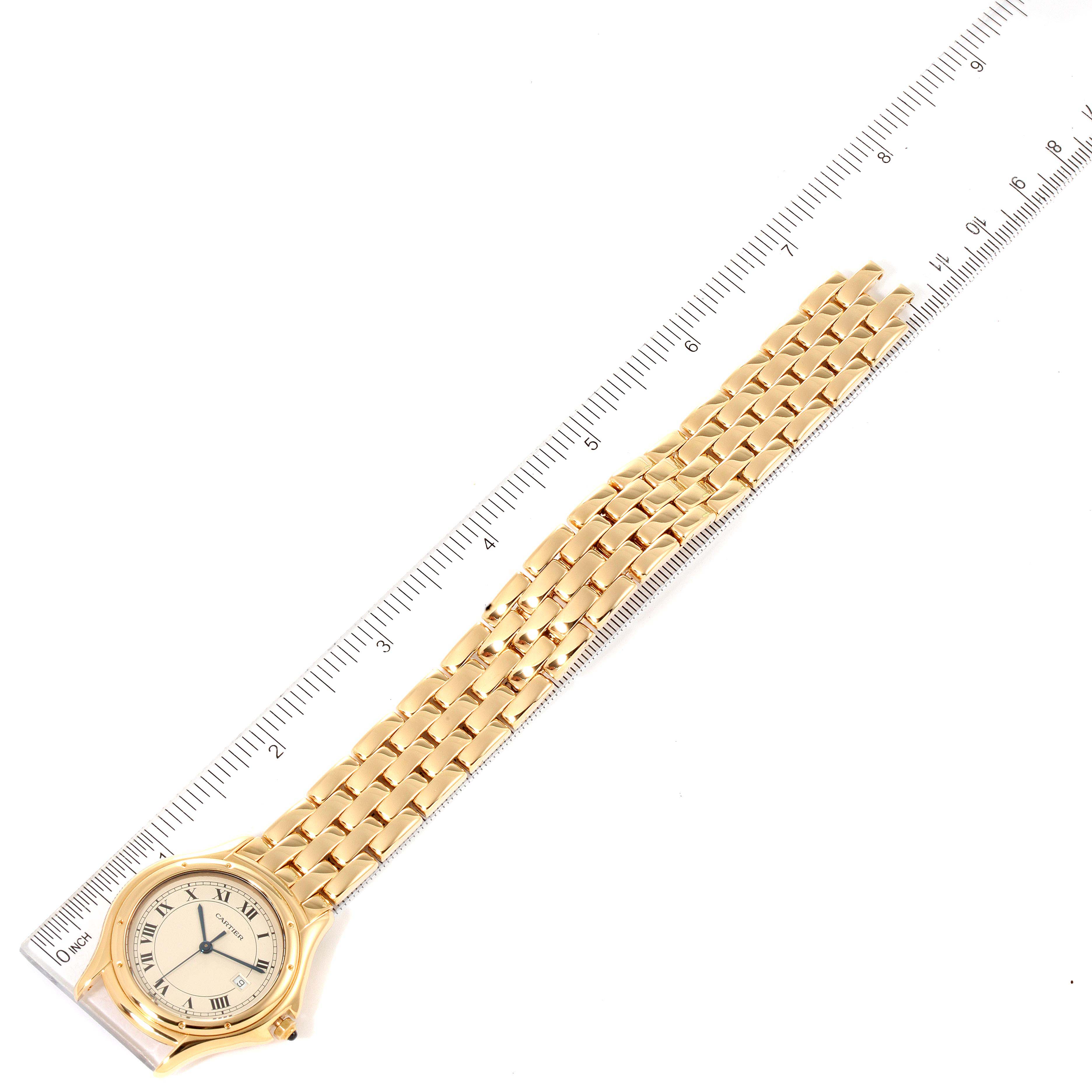 The image shows a Cartier Panthere 887904 Men's Yellow Gold Silver Dial 887904 Men's Yellow Gold Silver Dial watch lying flat next to a ruler, displaying its face and full bracelet length.