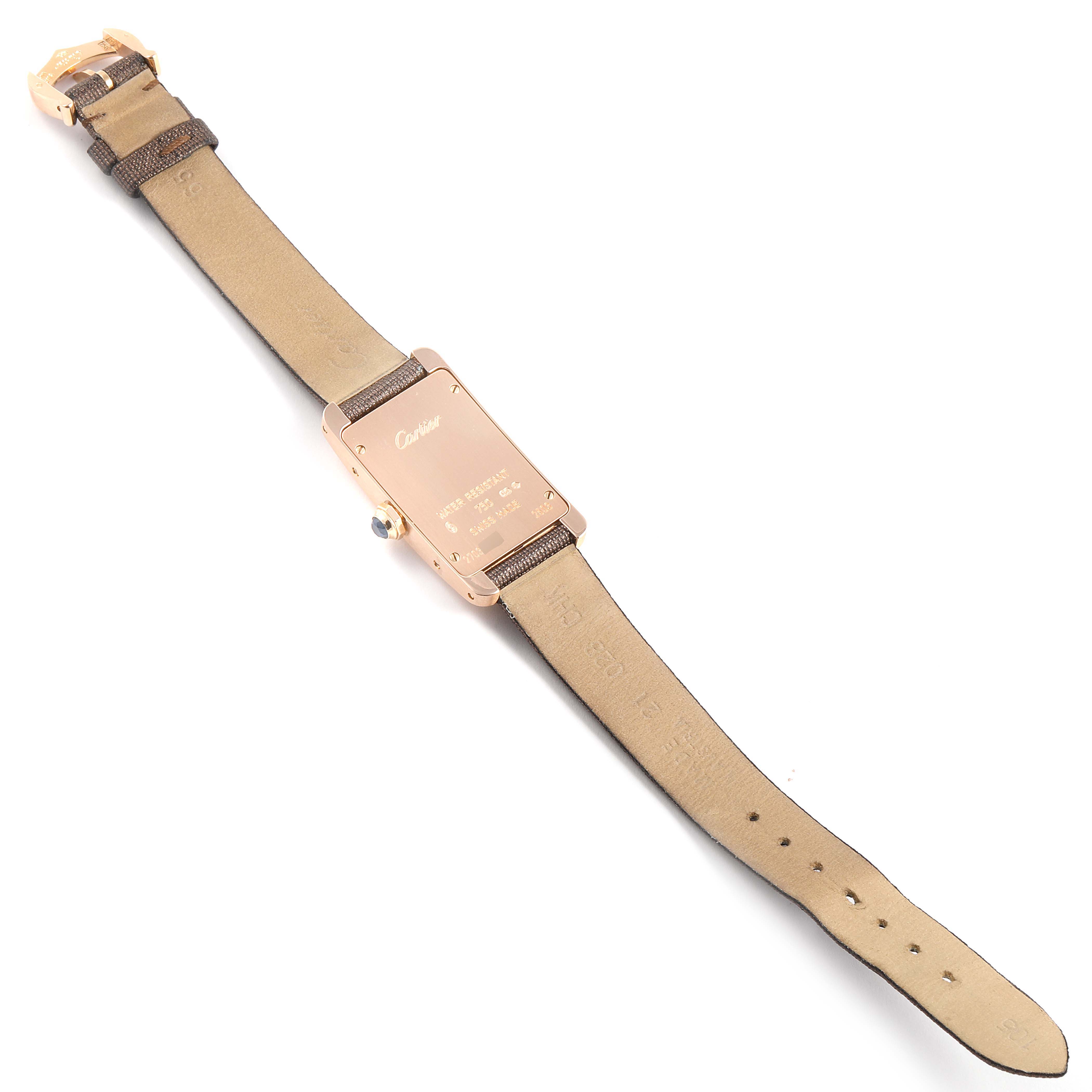 The image shows the back view of a Tank Americaine model watch by Cartier, including the strap and case back.