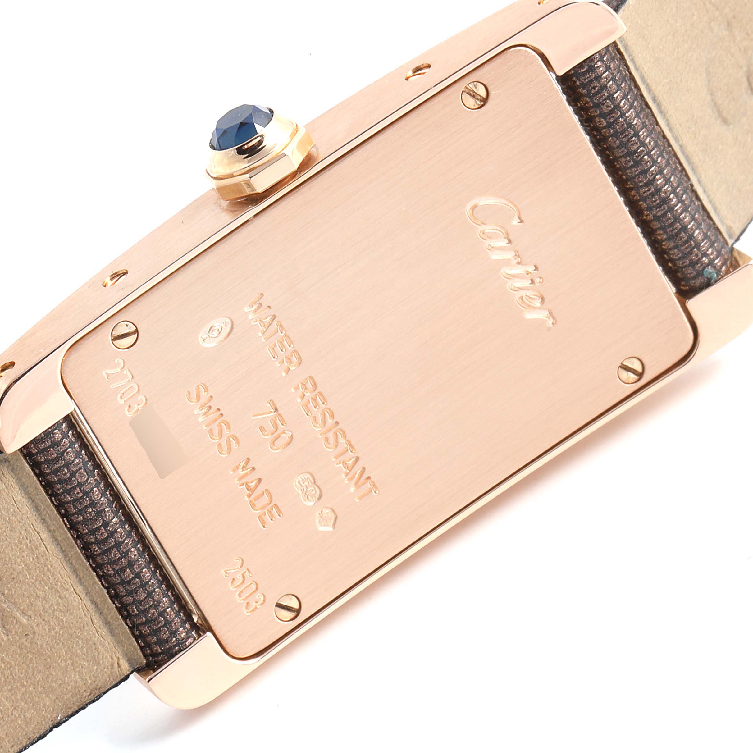 The image shows the back case and crown of a Cartier Tank Americaine 2503 Women's Rose Gold Pink Dial 2503 Women's Rose Gold Pink Dial watch, highlighting its markings and details.