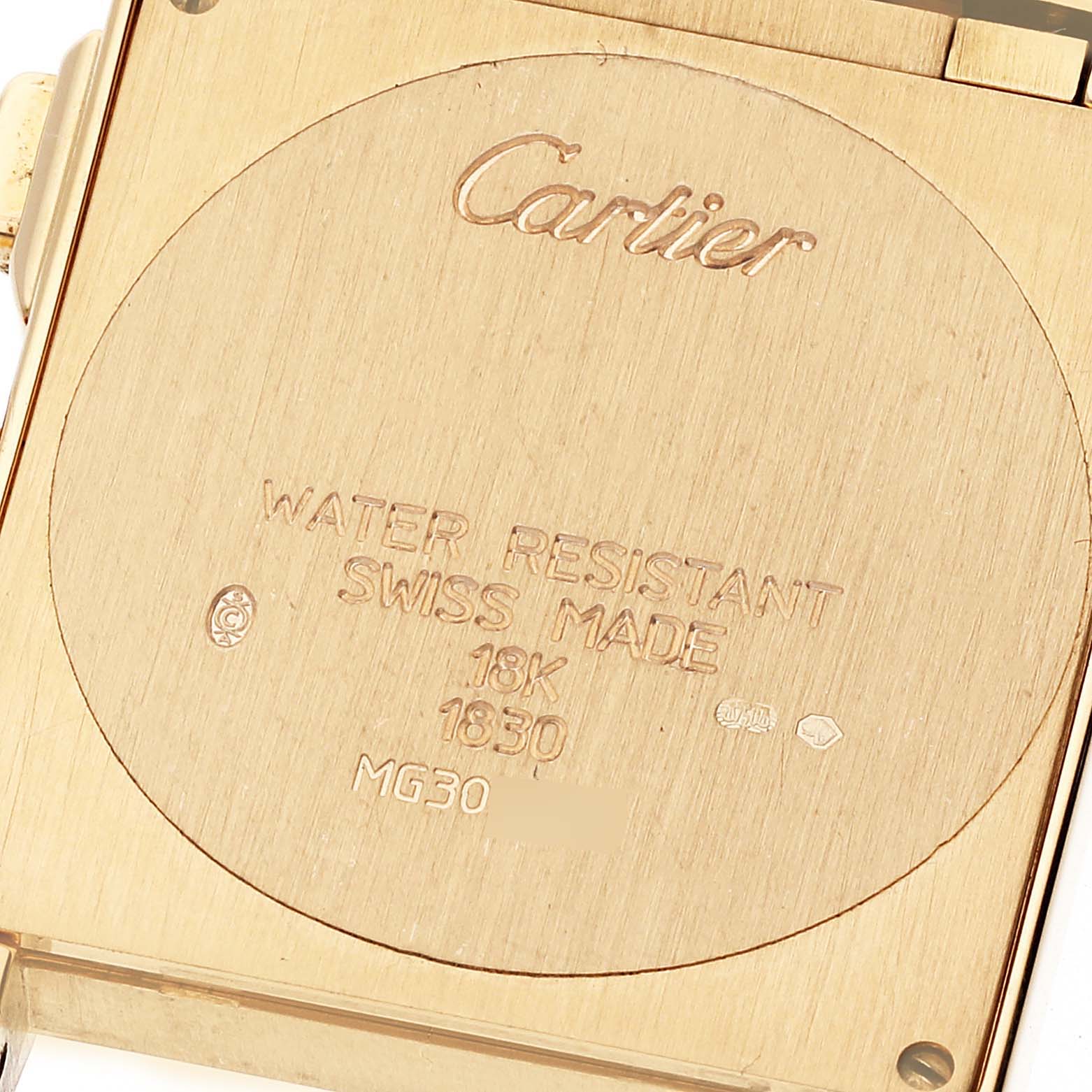 A close-up of the back of a Cartier Tank Francaise W50005R2 Men's Yellow Gold Silver Dial W50005R2 Men's Yellow Gold Silver Dial watch, showing engraved details on the gold plating.