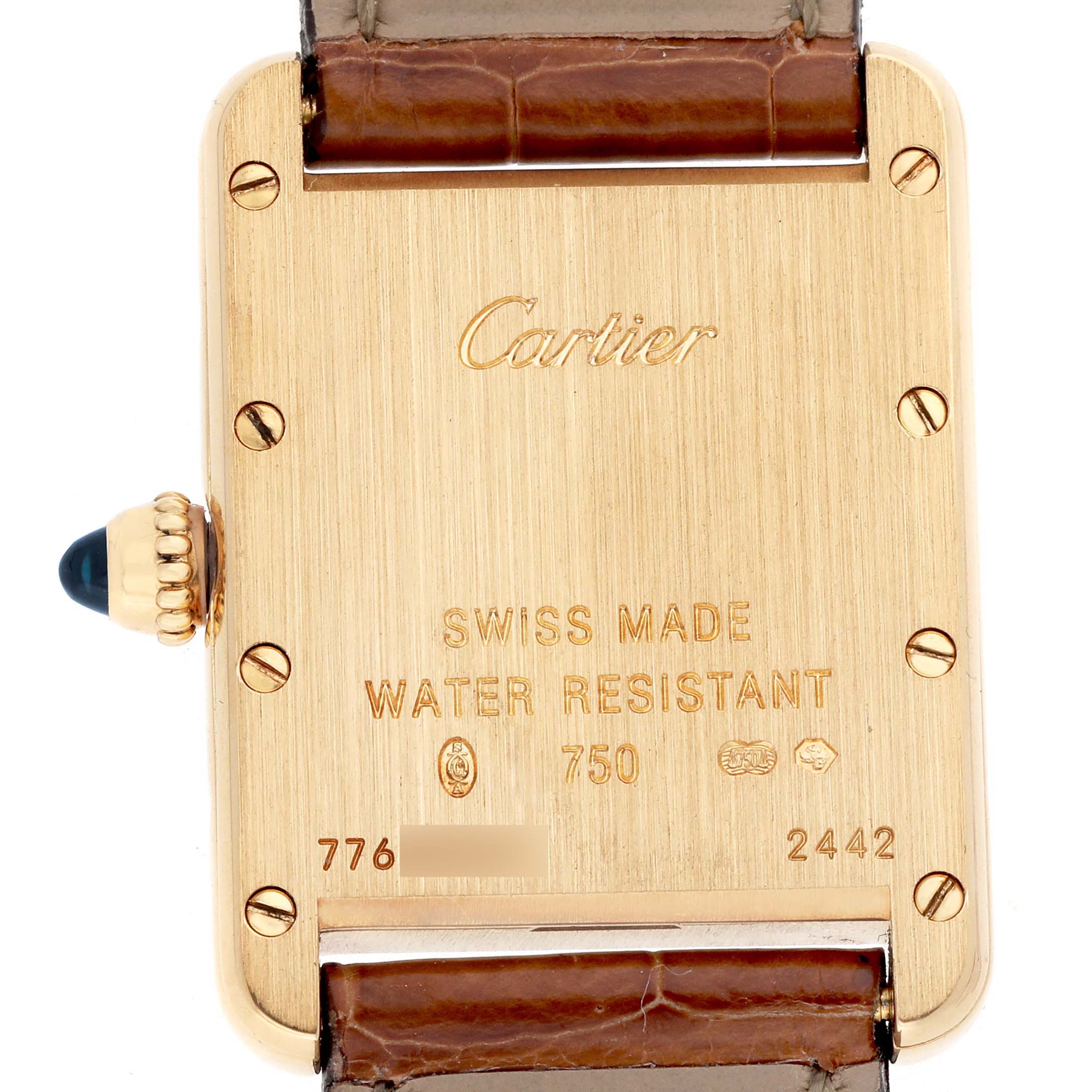 The image shows the back case of the Cartier Tank Louis W1529856 Women's Yellow Gold Silver Dial watch, highlighting engravings and the crown with a blue cabochon.