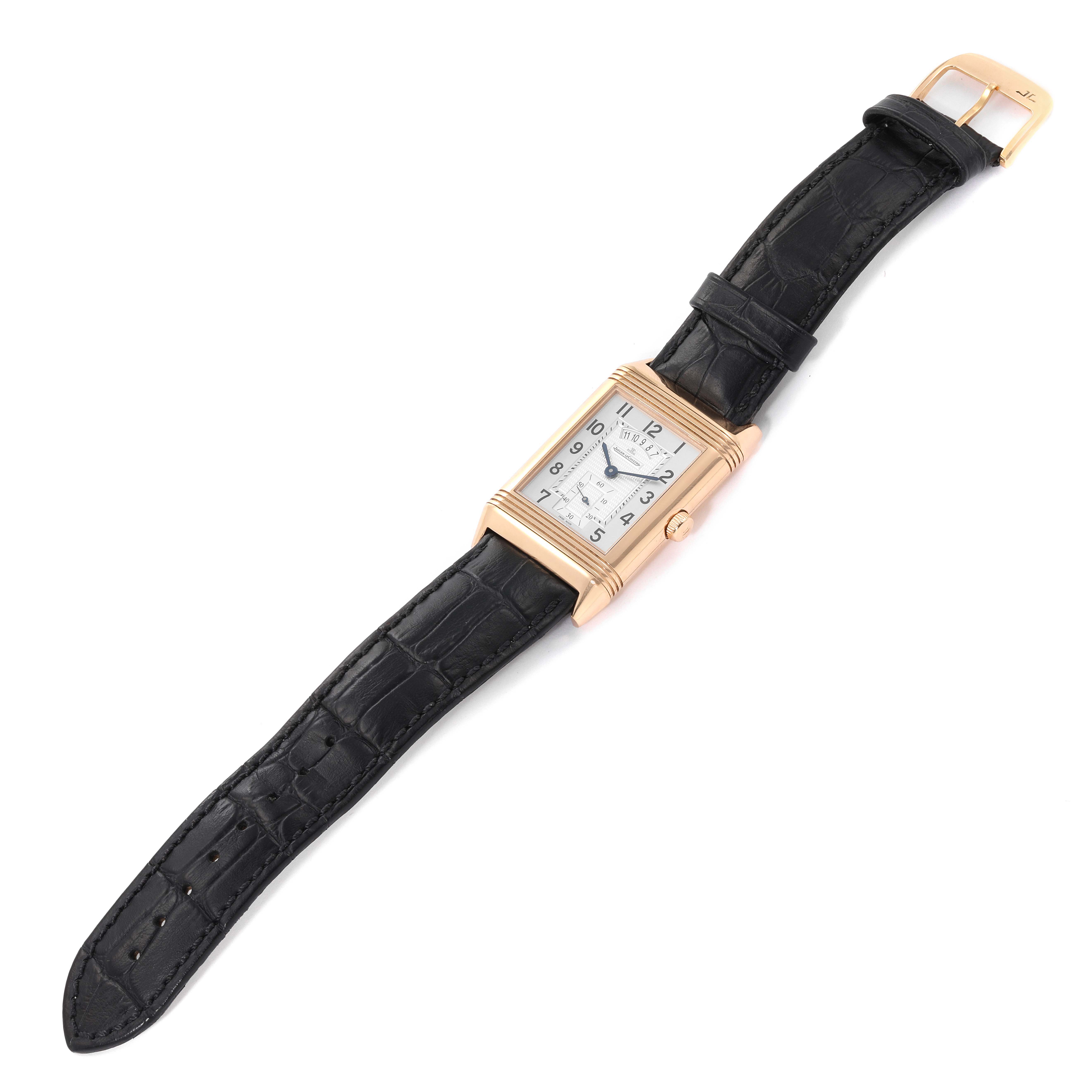 This image shows the Jaeger-LeCoultre Reverso watch laid flat, displaying the dial, case, crown, and black leather strap.