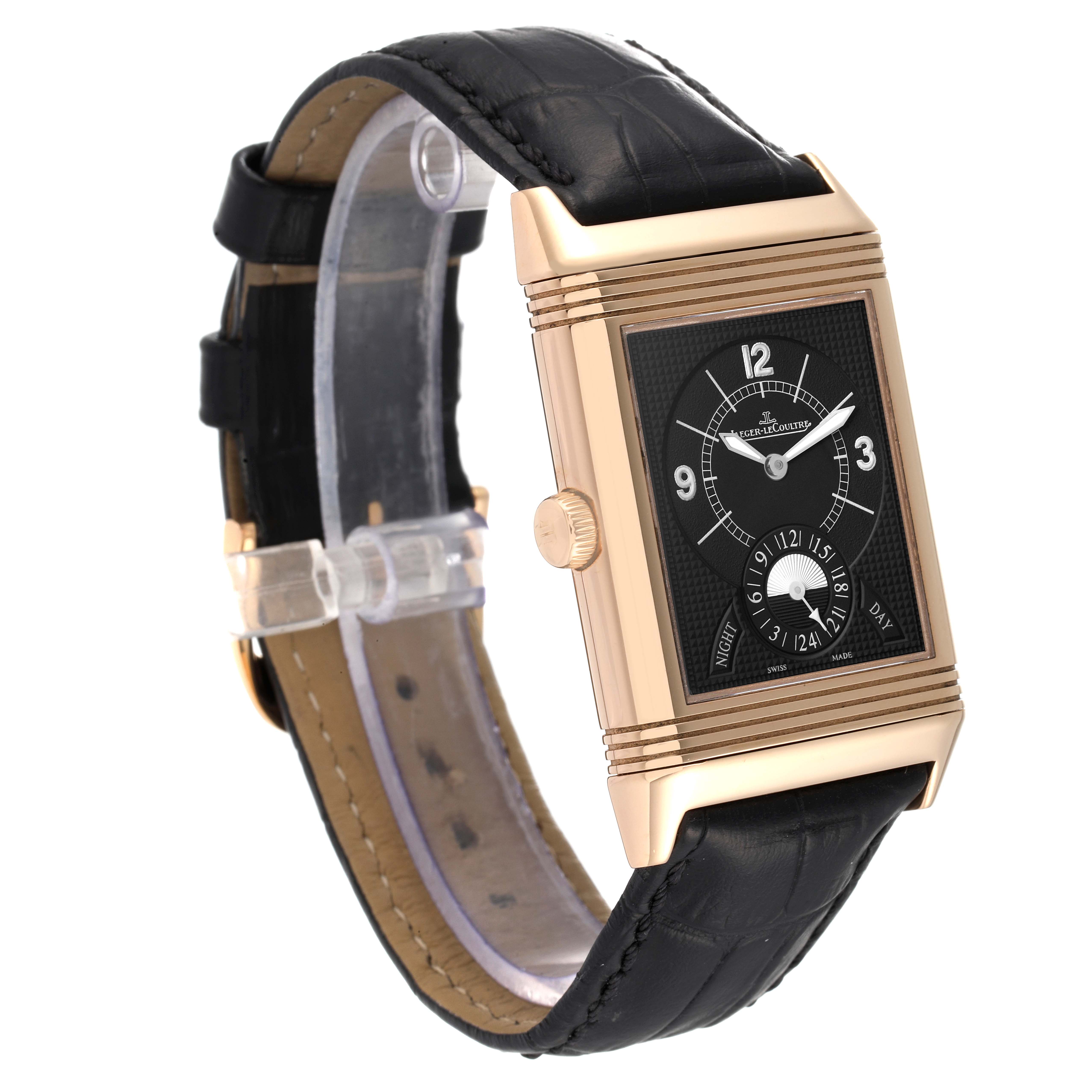 The Jaeger LeCoultre Reverso Q3742521 Men's Rose Gold Silver Dial Q3742521 Men's Rose Gold Silver Dial watch is shown at a slight side angle, displaying its rose gold case, black dial, and black leather strap.
