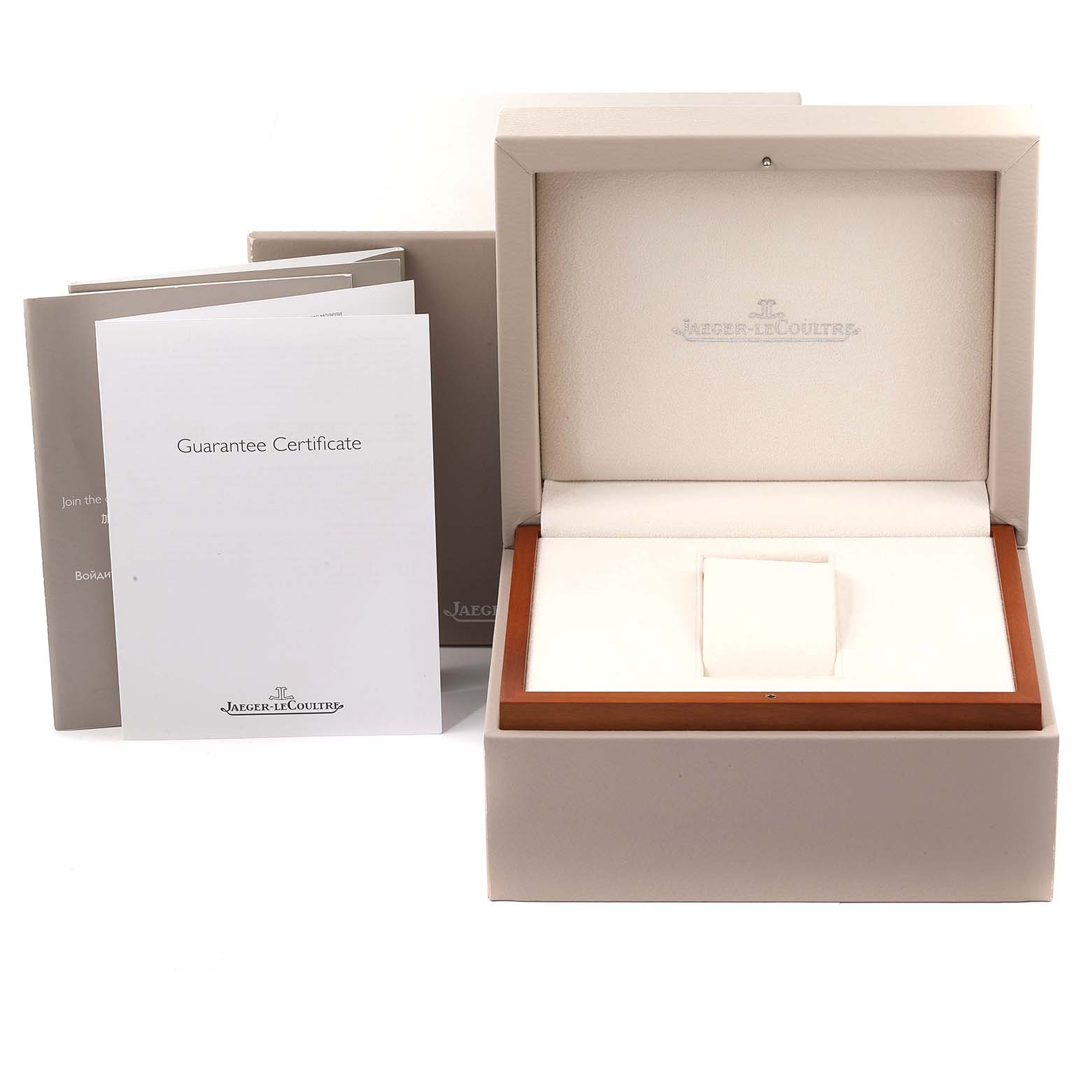 The image shows the packaging, guarantee certificate, and empty display box for a Jaeger-LeCoultre Reverso watch.