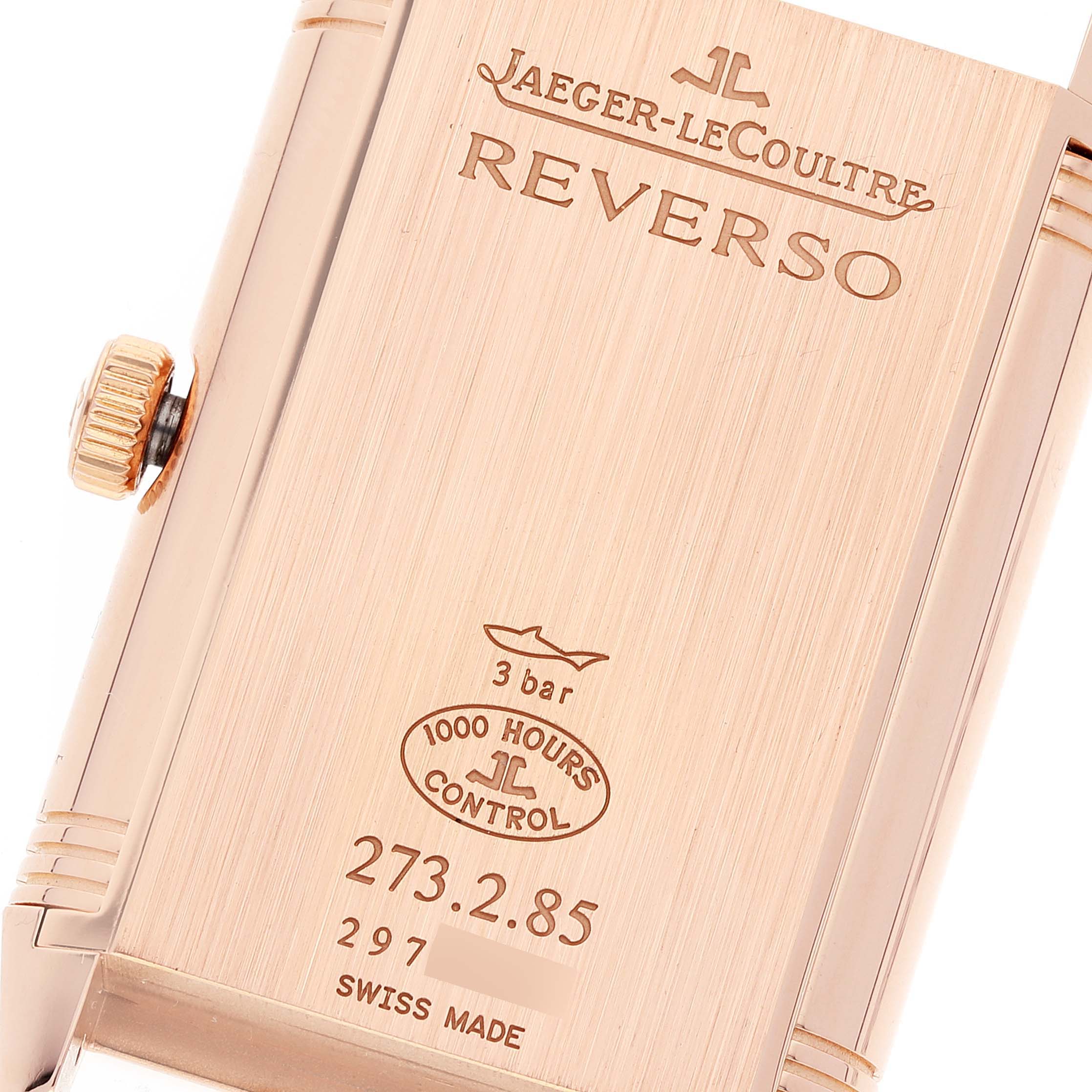 This image shows the back case and crown of the Jaeger-LeCoultre Reverso watch, highlighting engravings and details.