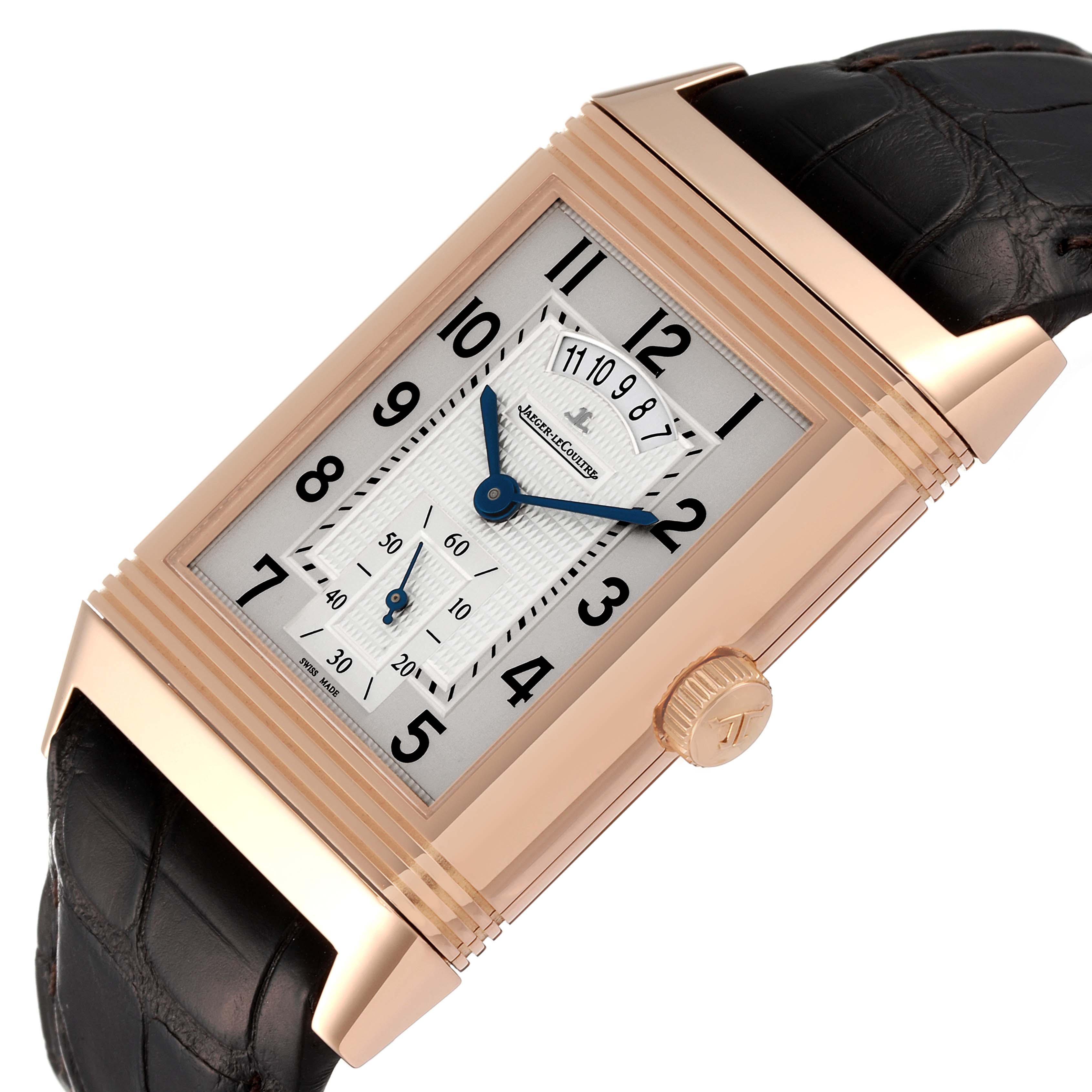 The Jaeger-LeCoultre Reverso watch is shown at an angle, highlighting the rectangular dial, crown, and leather strap.