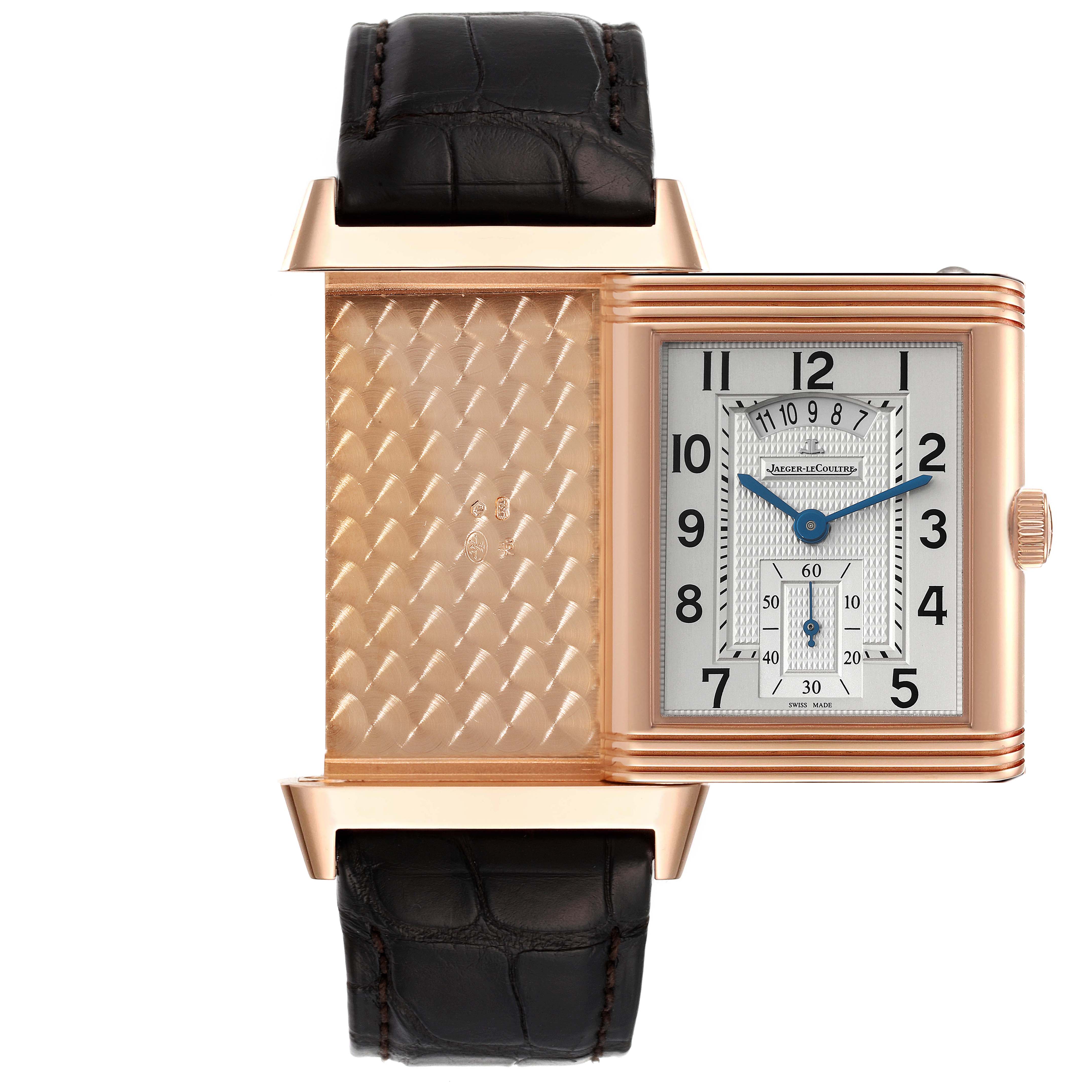 The image shows a Jaeger-LeCoultre Reverso watch with its case partially rotated, exposing the decorative back.