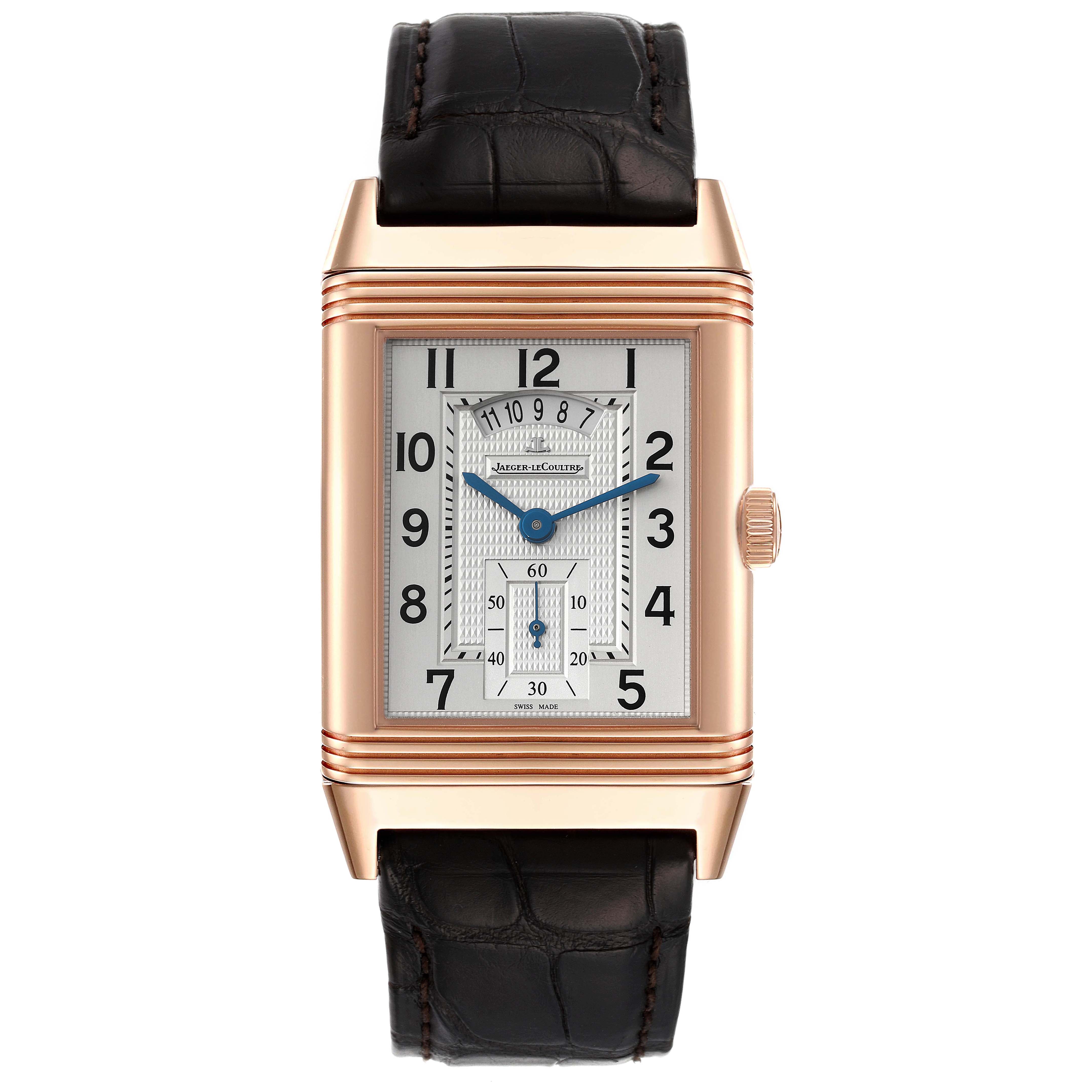 The Jaeger-LeCoultre Reverso watch is shown from the front, displaying its rectangular dial and leather strap.
