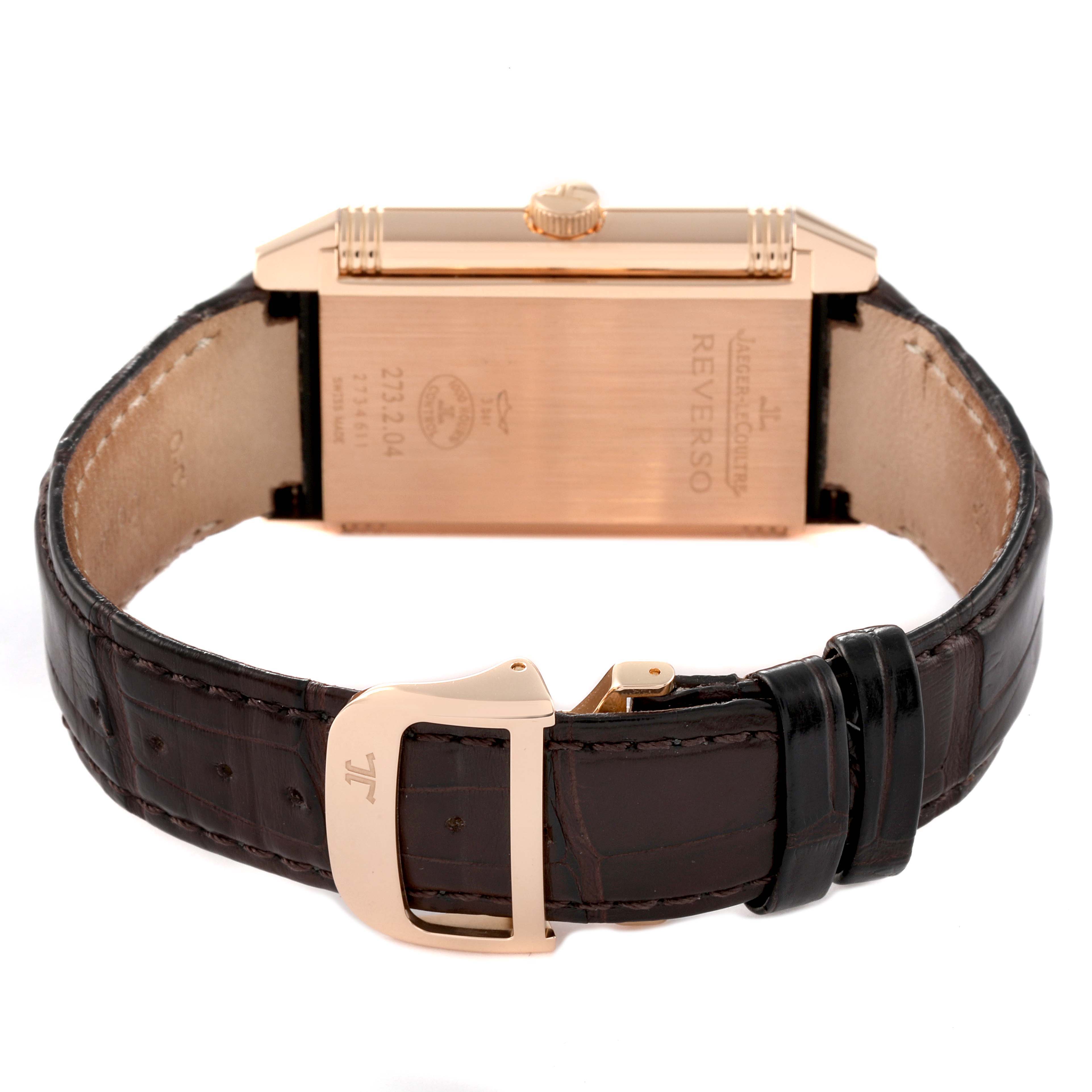 The image shows the back view of a Jaeger LeCoultre Reverso Q3732420 Men's Rose Gold Silver Dial Q3732420 Men's Rose Gold Silver Dial watch, highlighting the case back, crown, and leather strap with a deployment clasp.