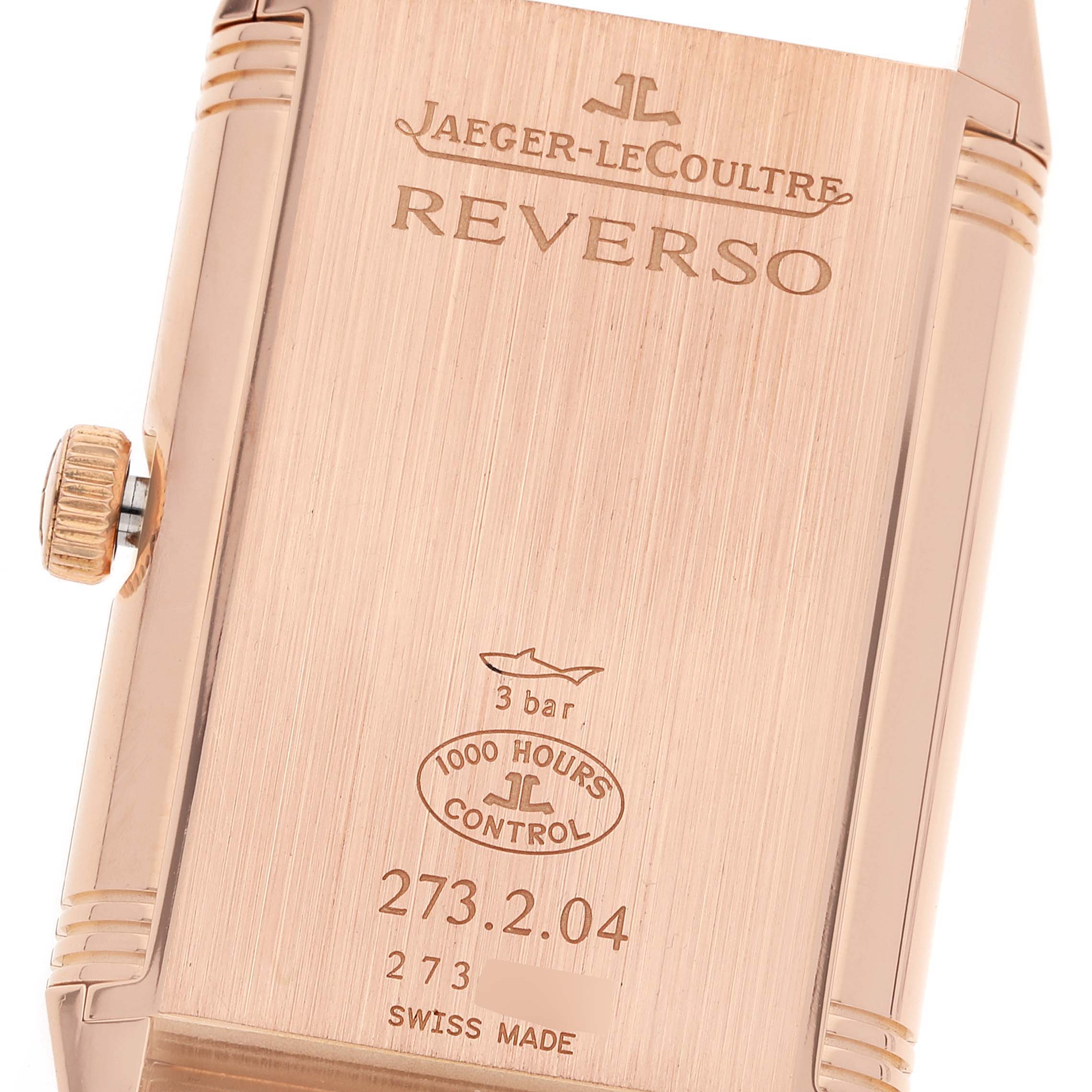The image shows the back case and crown of the Jaeger-LeCoultre Reverso watch, highlighting the engraved details.