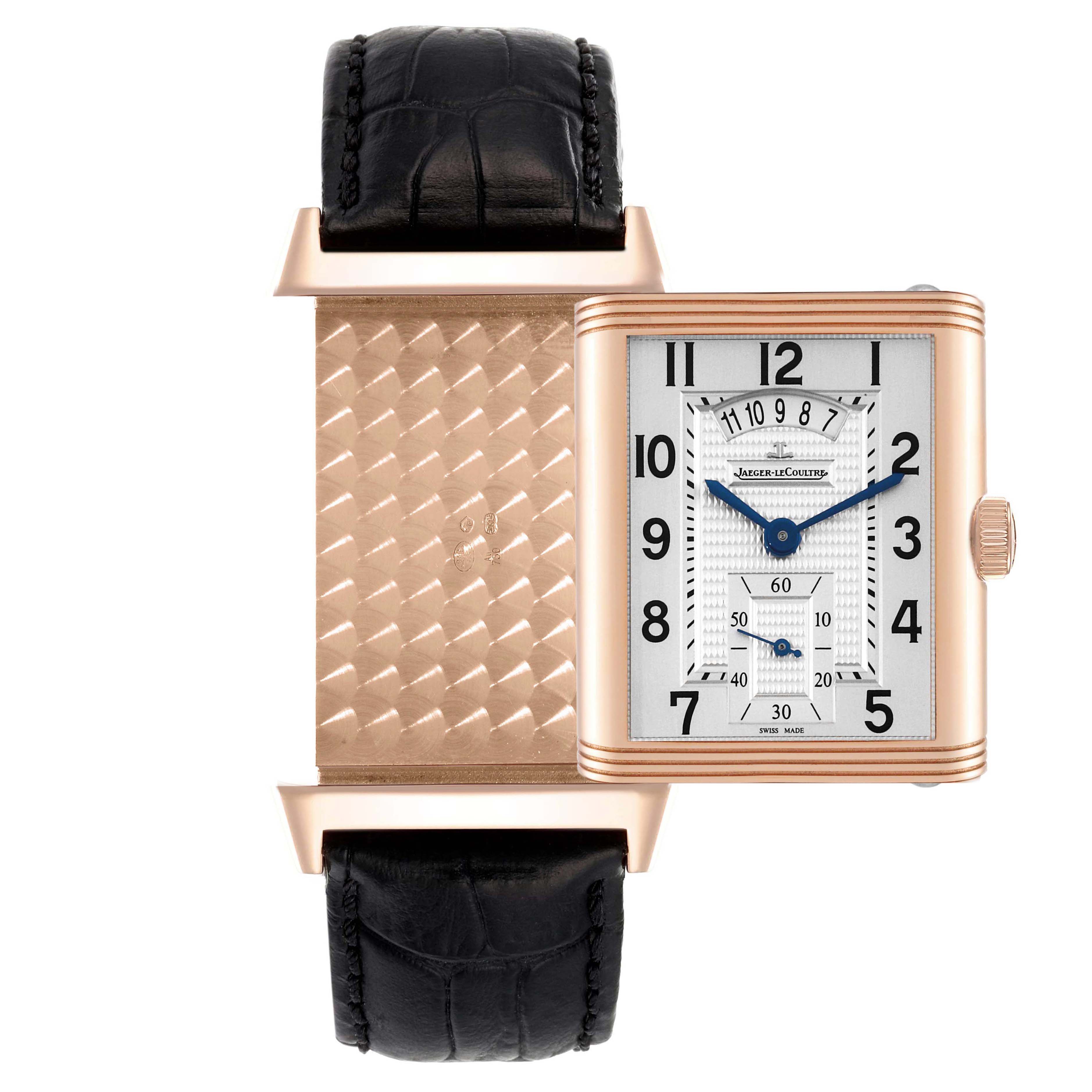 The image shows a Jaeger-LeCoultre Reverso watch with its case open, revealing both the textured back and the face with black numerals.