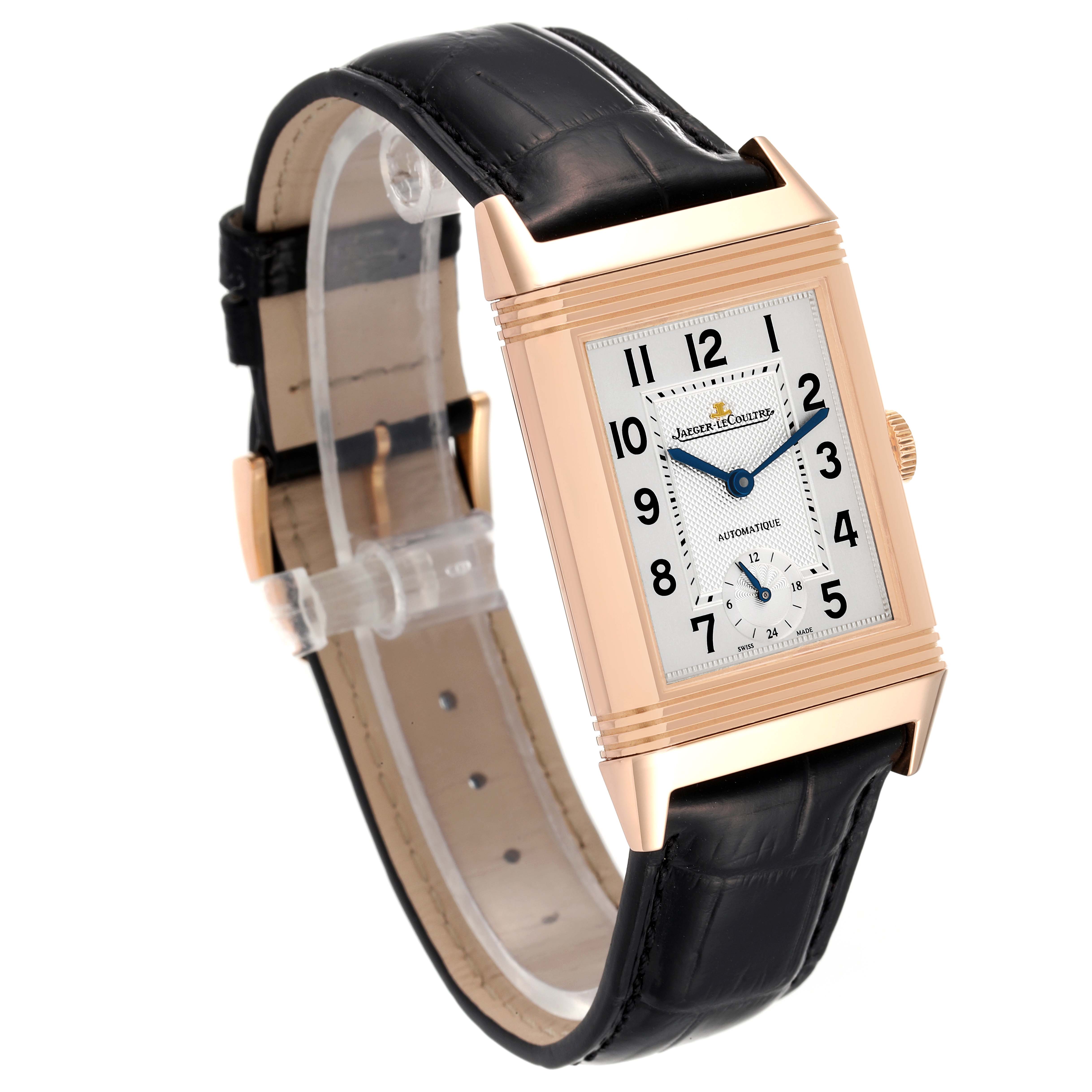 The image shows a Jaeger LeCoultre Reverso Q3802520 Men
s Rose Gold Silver Dial Q3802520 Men
s Rose Gold Silver Dial watch from an angled side view, highlighting its rectangular face and black leather strap.