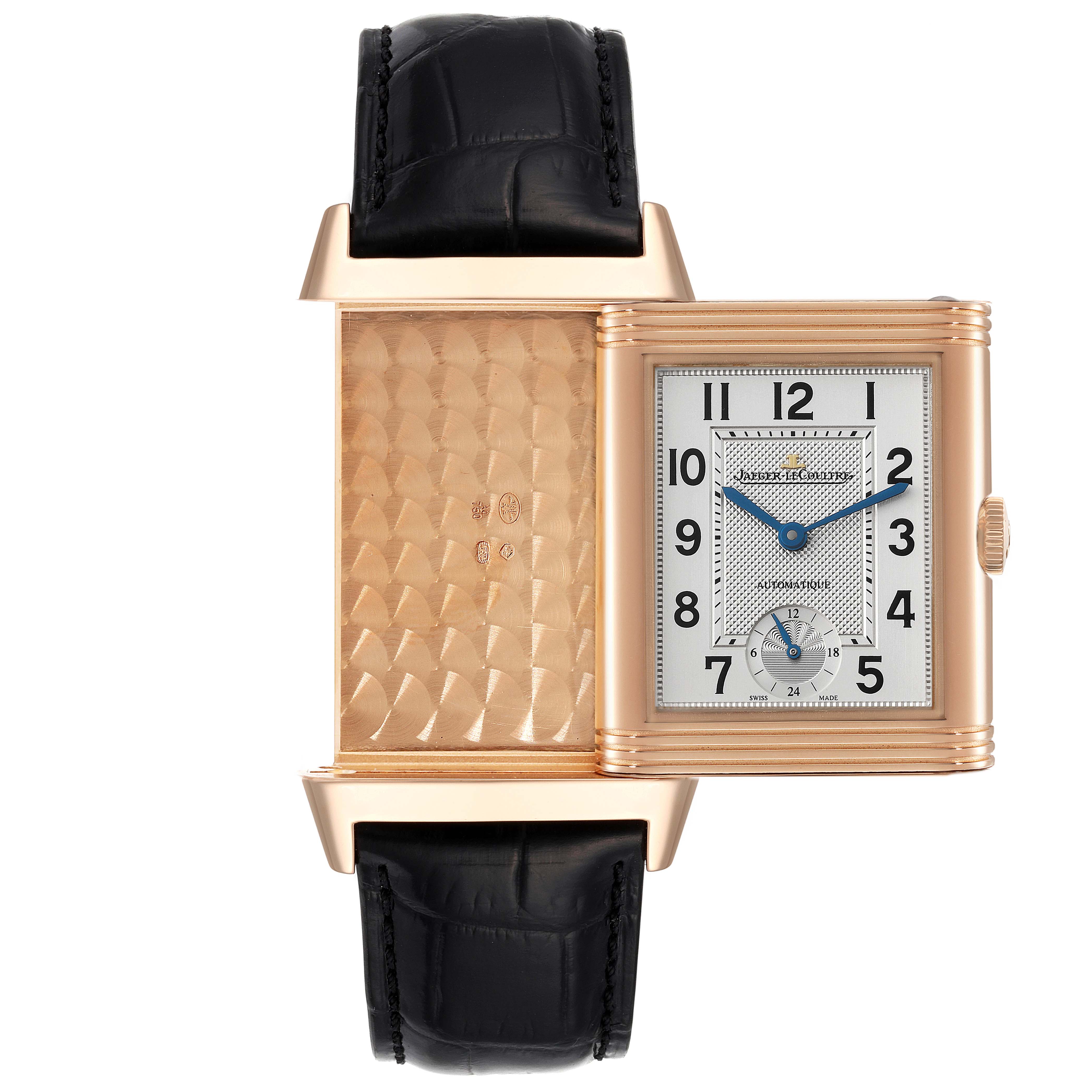 This image shows a Jaeger-LeCoultre Reverso watch at a frontal angle, with its reversible face partially flipped to reveal the engraved back.