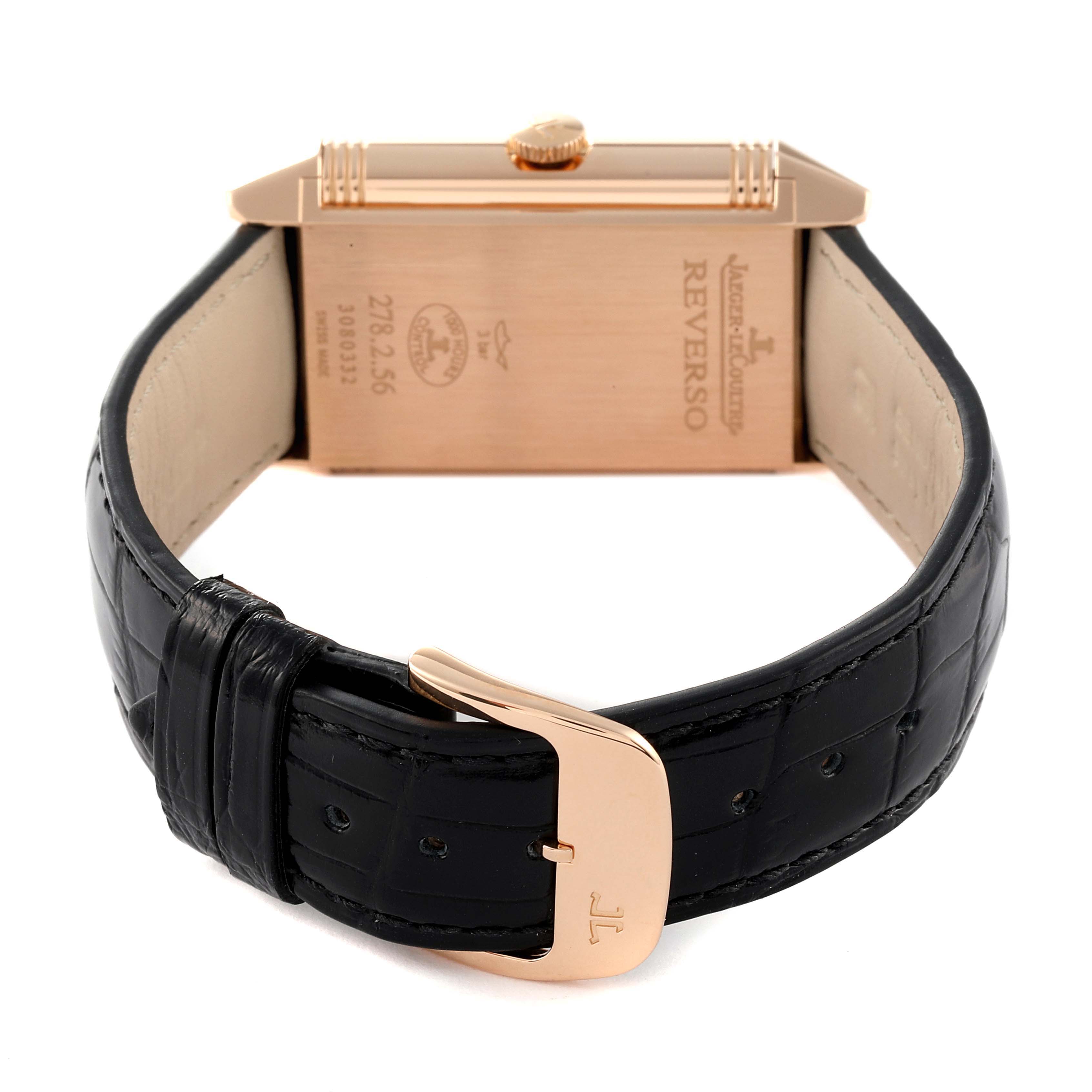 The image shows the back view of a Jaeger LeCoultre Reverso Q3802520 Men
s Rose Gold Silver Dial Q3802520 Men
s Rose Gold Silver Dial watch, focusing on the case, crown, and black leather strap with a buckle.