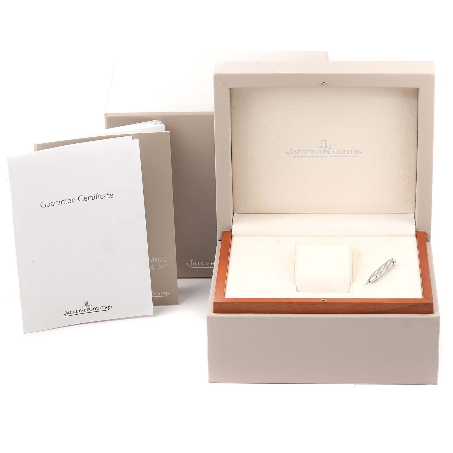 This image shows the box, guarantee certificate, and holder for a Jaeger-LeCoultre Reverso model watch.
