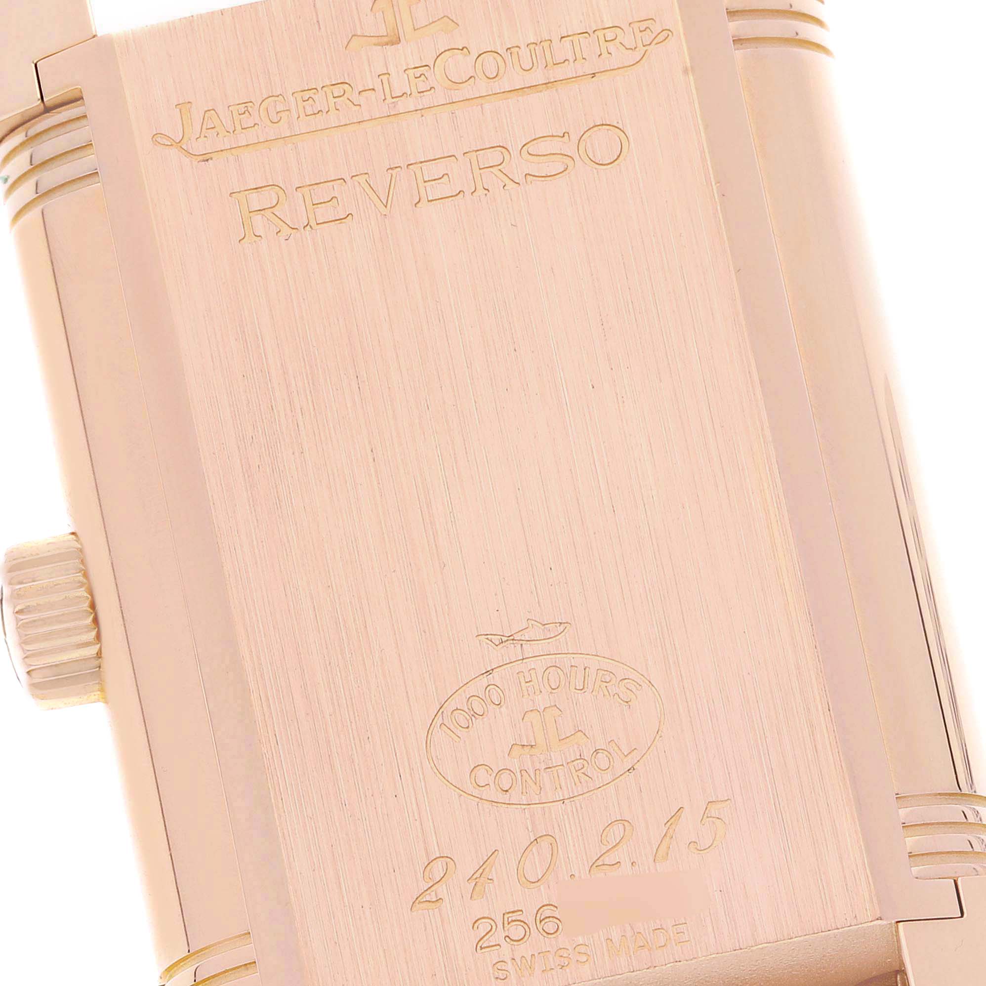 The image shows the back of a Jaeger-LeCoultre Reverso watch, highlighting the engravings and case edge with the crown visible.