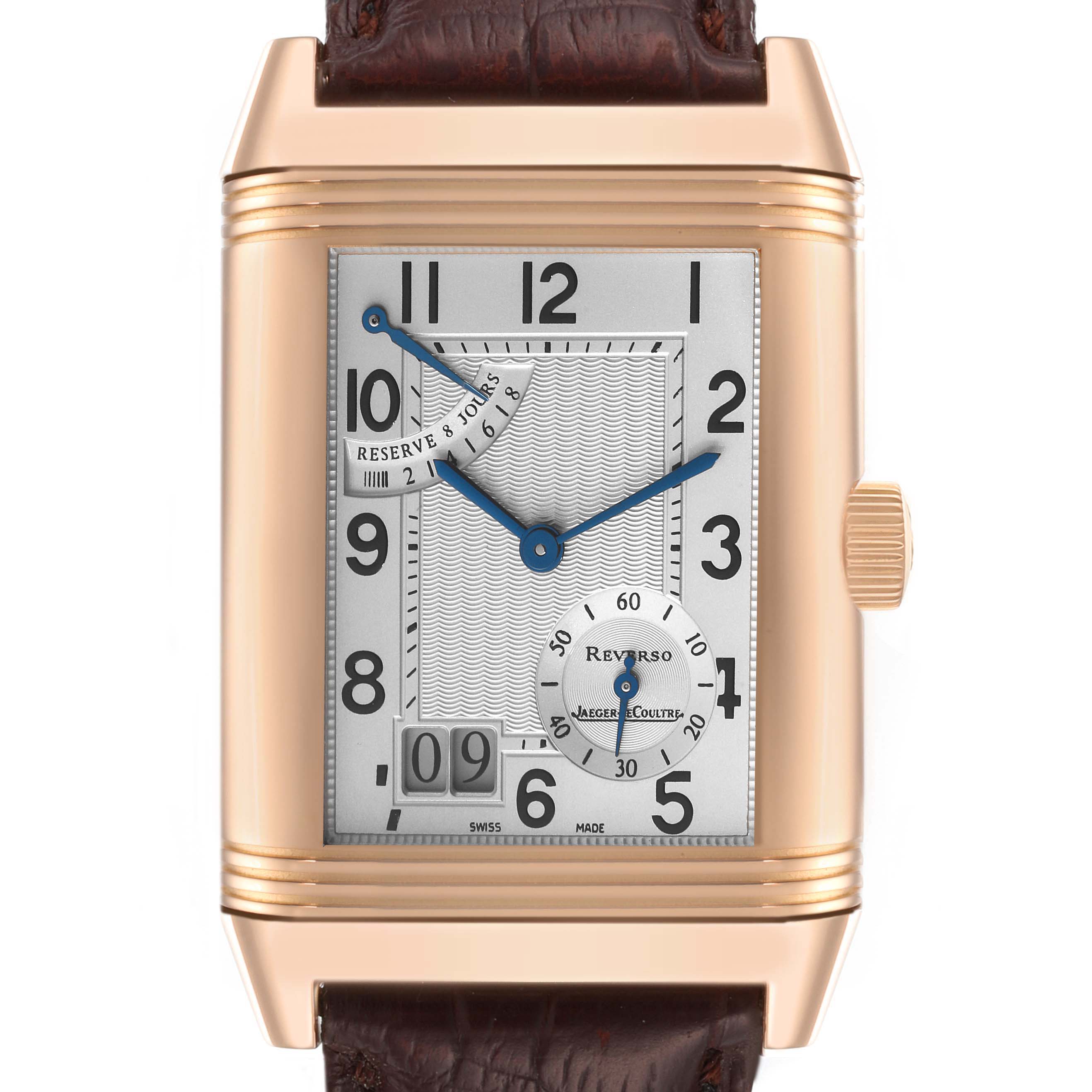 The Jaeger-LeCoultre Reverso watch is shown from a front angle, displaying its dial, hands, date, and leather strap.