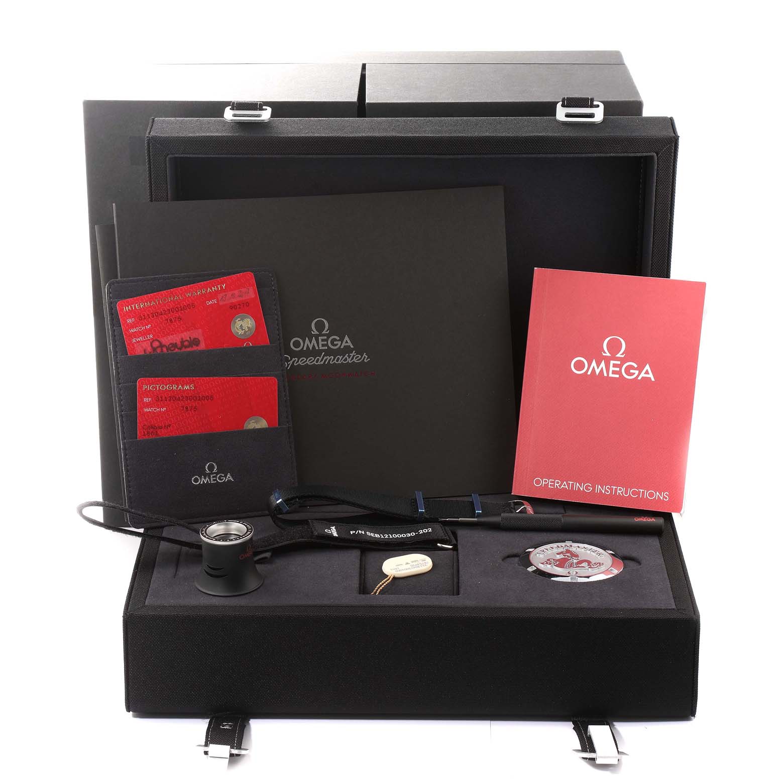 The image shows the Omega Speedmaster 311.30.42.30.01.005 Men's Stainless Steel Black Dial 311.30.42.30.01.005 Men's Stainless Steel Black Dial box, including manuals, warranty cards, a magnifying glass, and a special tool.