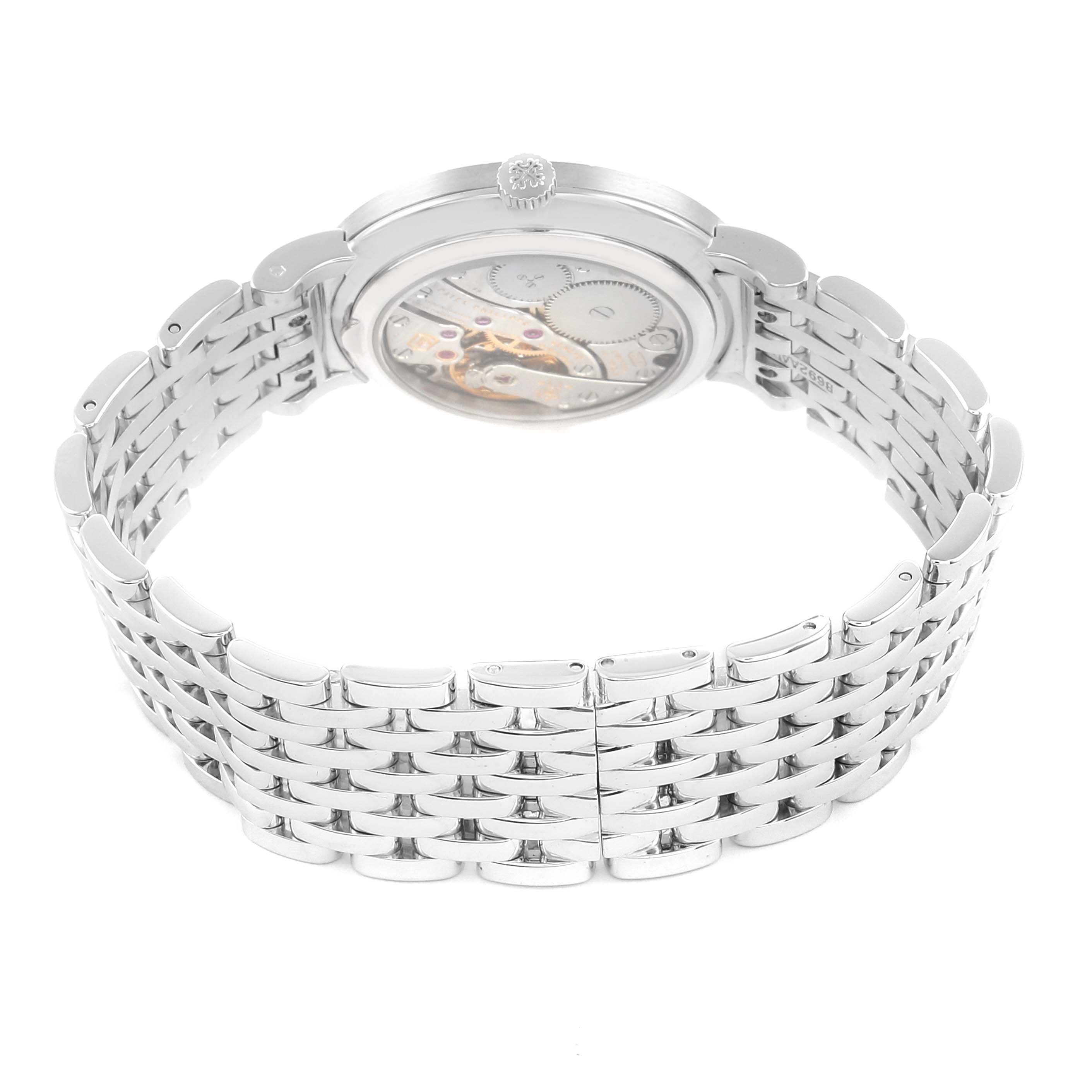 The image shows the back and side of the Patek Philippe Calatrava 7119 Women's White Gold White Dial, highlighting its bracelet and mechanical movement.