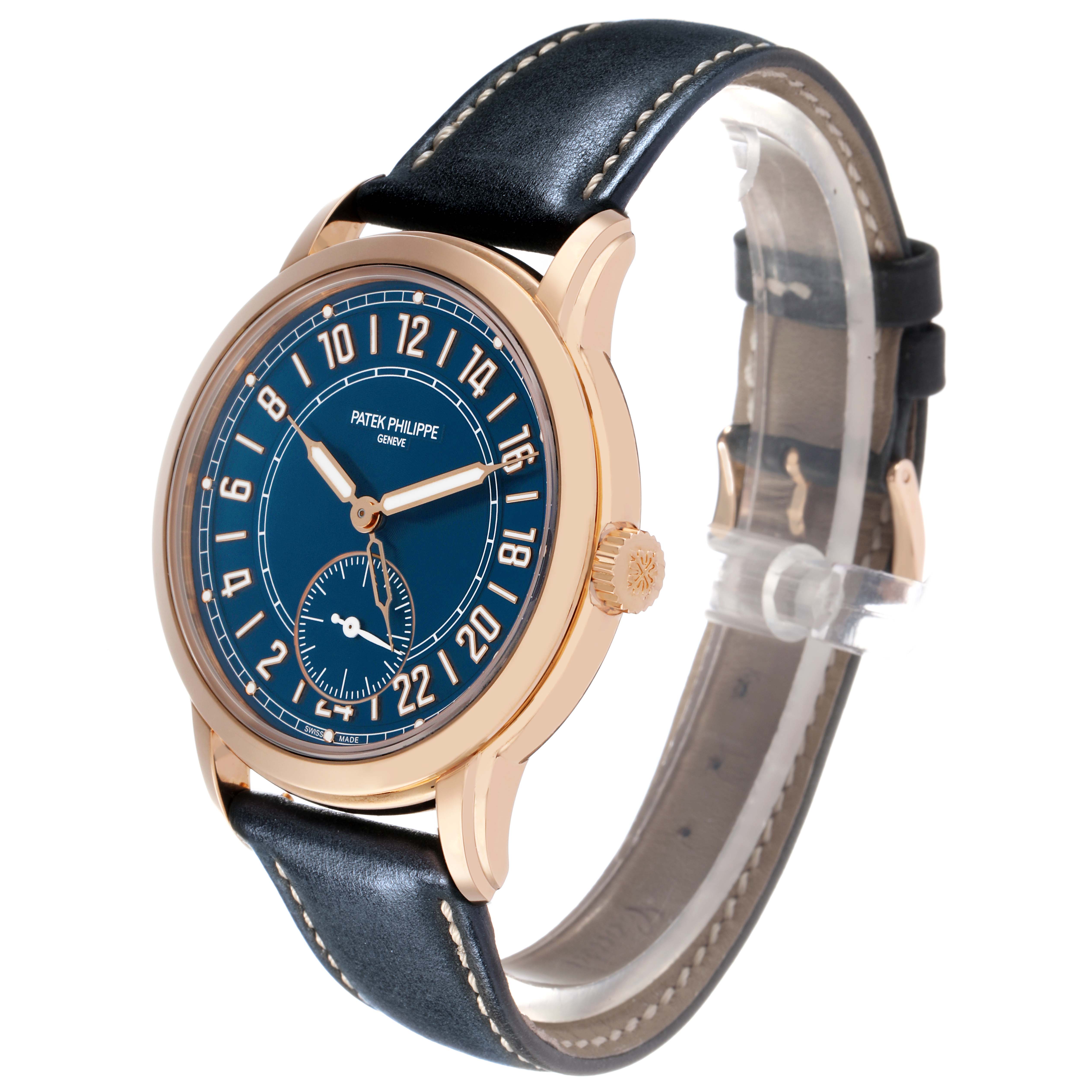 The Patek Philippe Calatrava 5224R-001 Men's Rose Gold Blue Dial watch is shown at a three-quarter angle, highlighting the blue dial, rose gold case, and black leather strap.