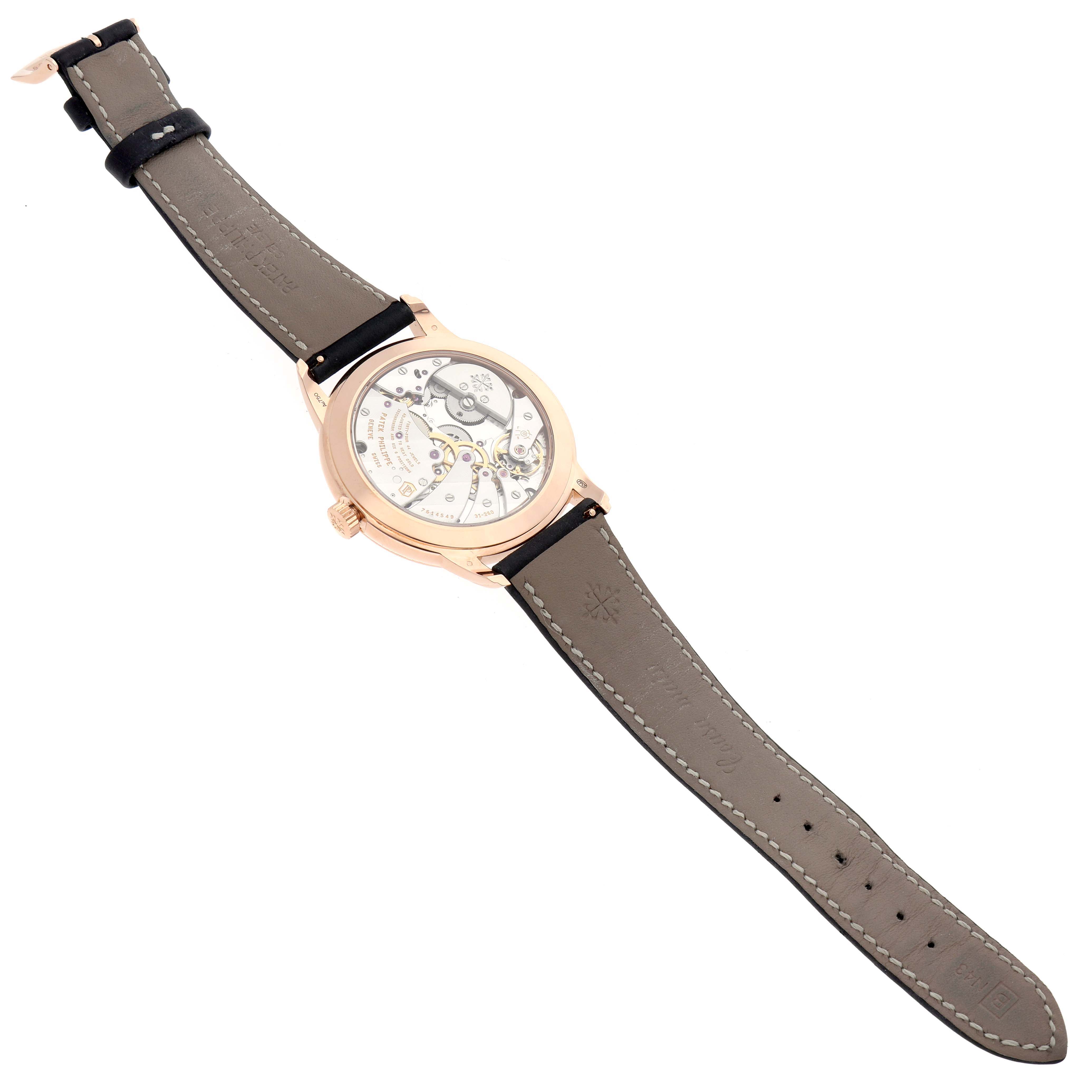 The image shows the back view of a Patek Philippe Calatrava 5224R-001 Men's Rose Gold Blue Dial watch, highlighting the movement and leather strap.