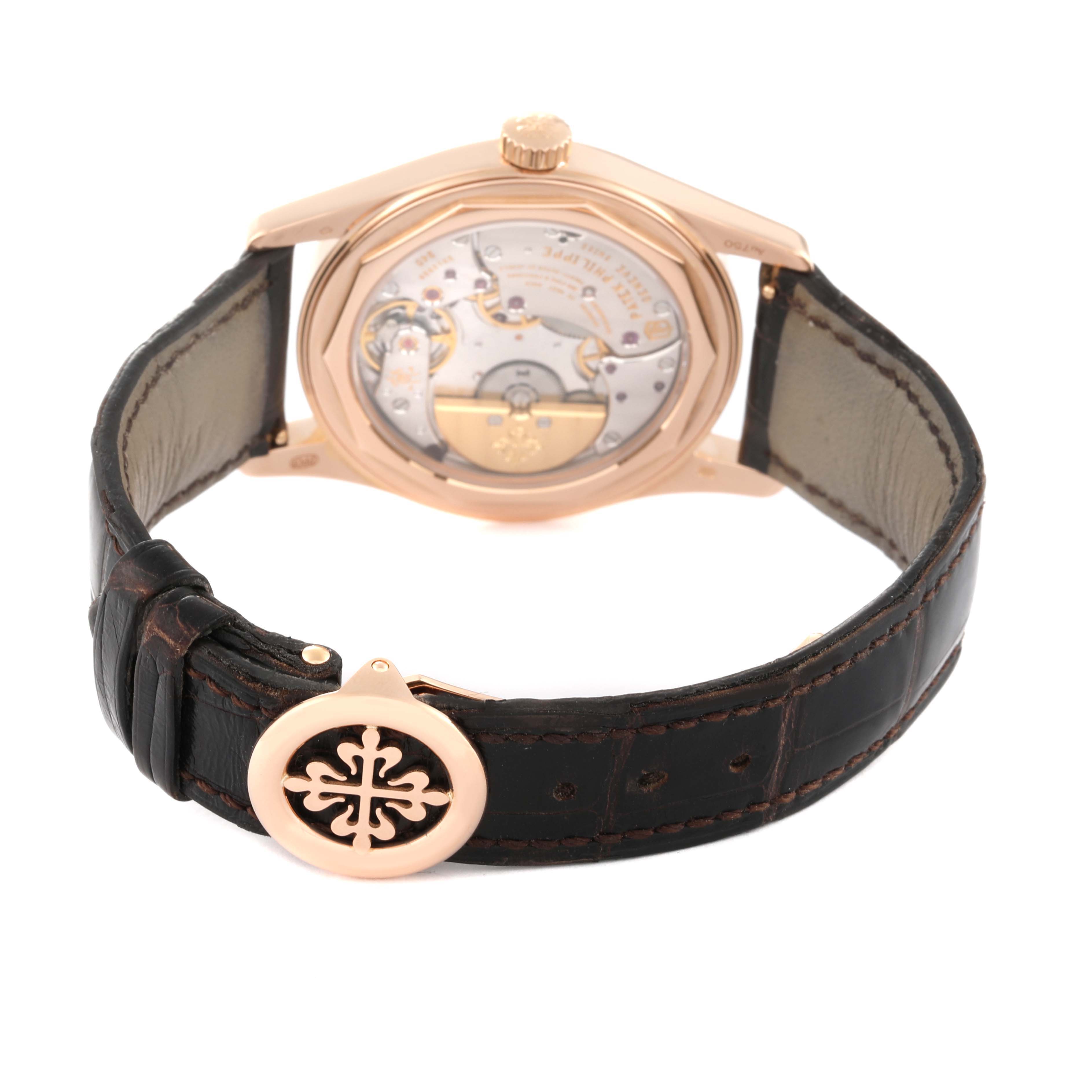 The image shows the back view of the Patek Philippe Calatrava 6000R-001 Men's Rose Gold Brown Dial 6000R-001 Men's Rose Gold Brown Dial watch, showcasing its mechanical movement and leather strap.