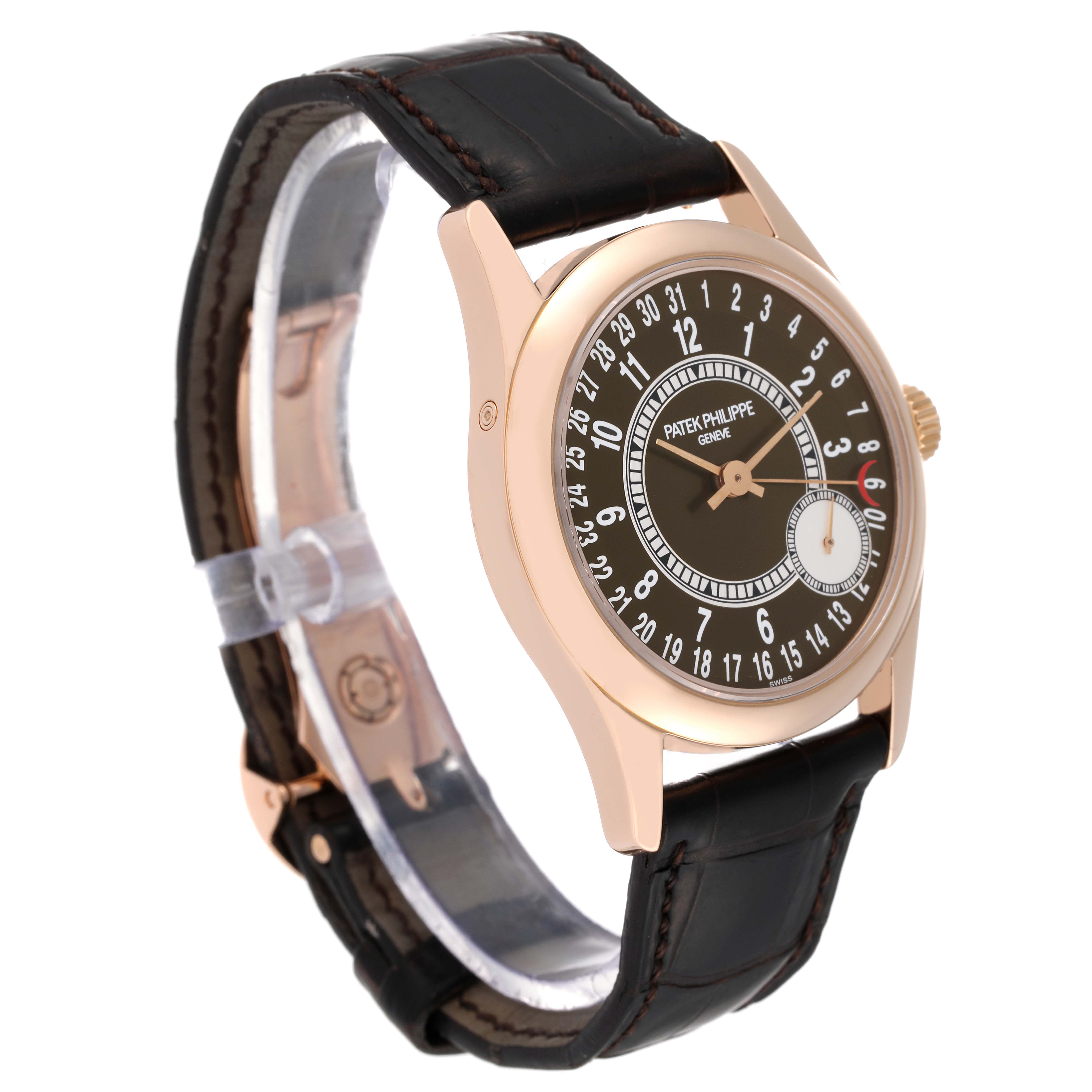 The Patek Philippe Calatrava 6000R-001 Men's Rose Gold Brown Dial 6000R-001 Men's Rose Gold Brown Dial watch is shown at a three-quarter angle, displaying its dial, case, and leather strap.