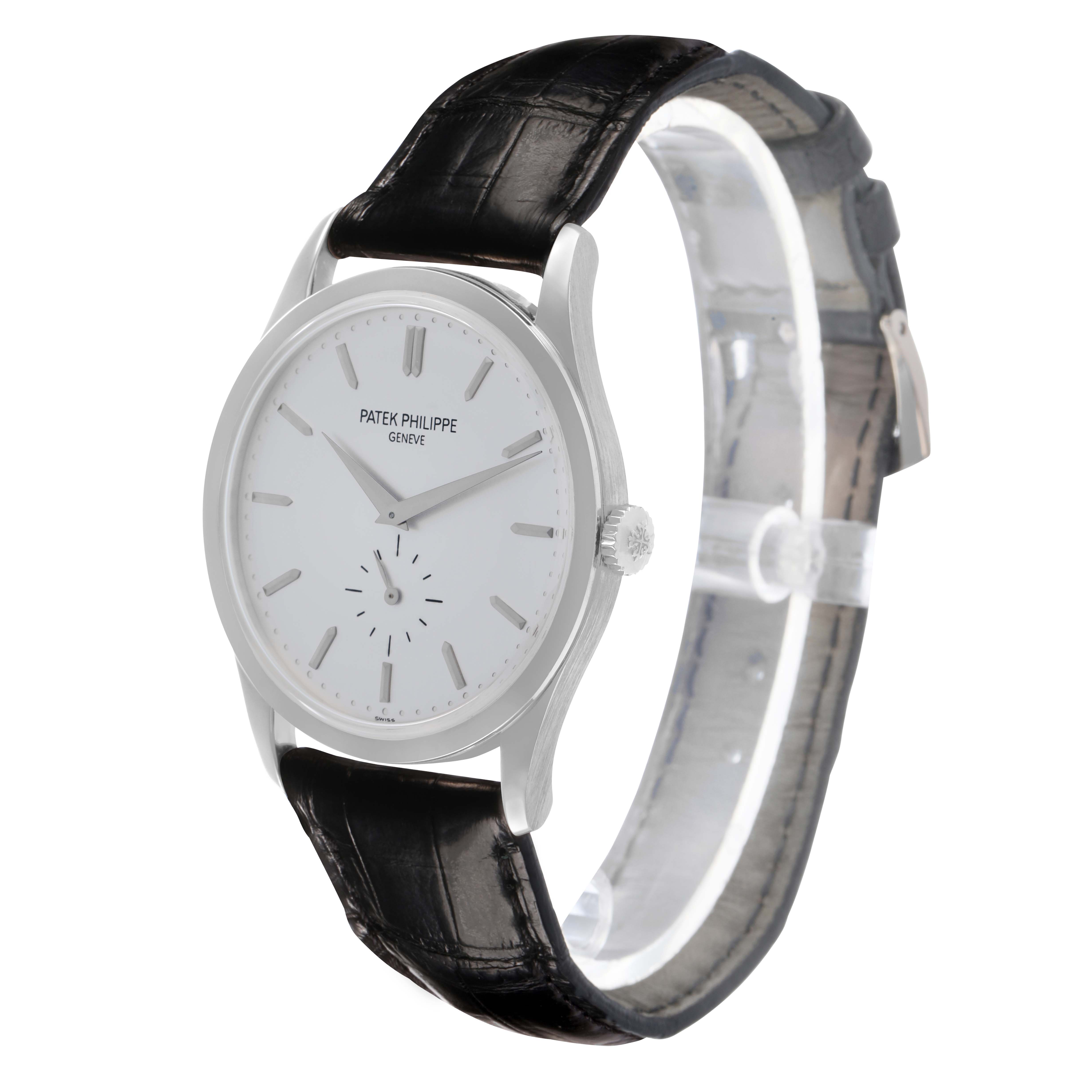 The Patek Philippe Calatrava 5196 Men
s White Gold Silver Dial watch is shown at a slight angle, highlighting the face, case, crown, and leather strap.