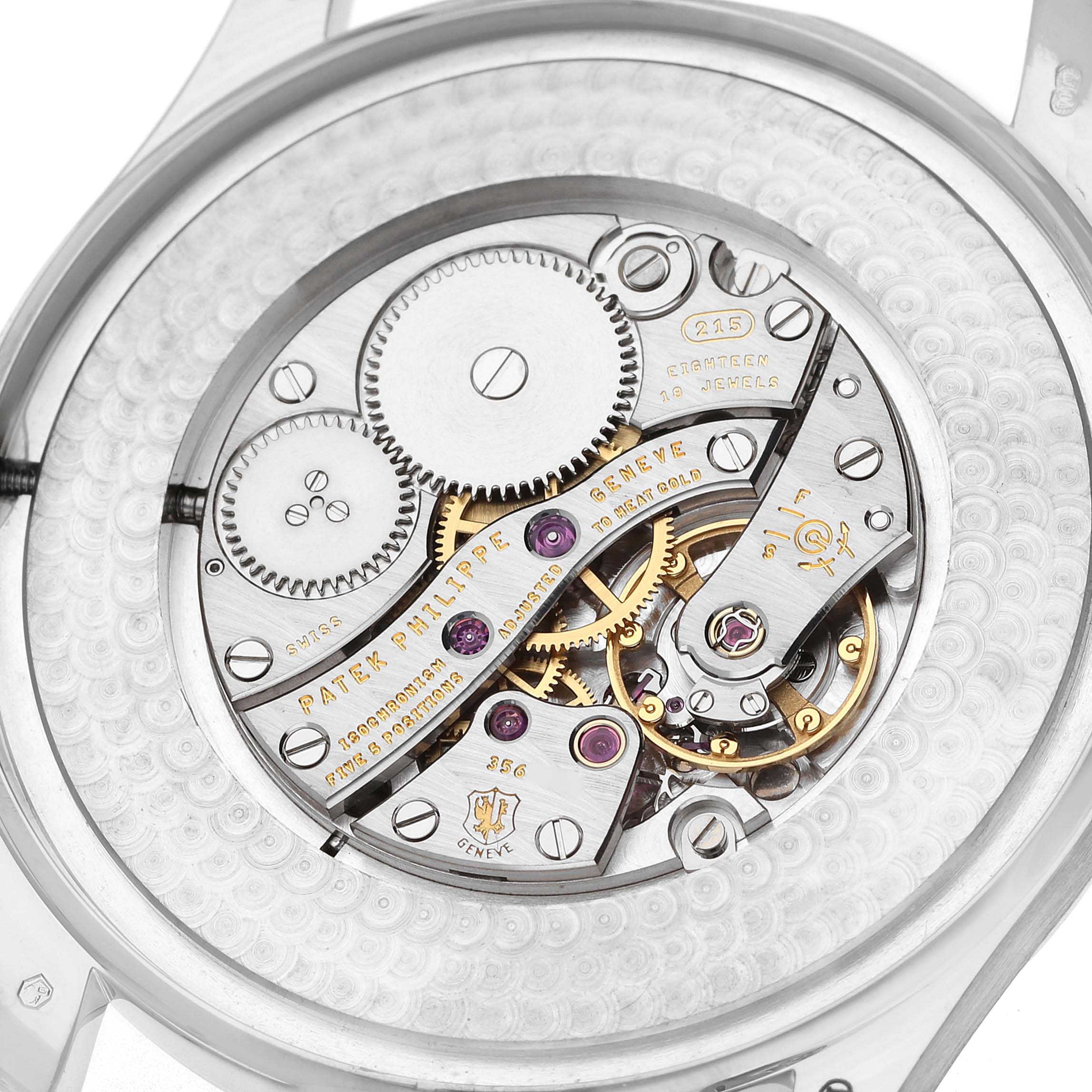 This image shows the intricate movement of a Patek Philippe Calatrava 5196 Men
s White Gold Silver Dial watch from the back, highlighting the gears and jewels.