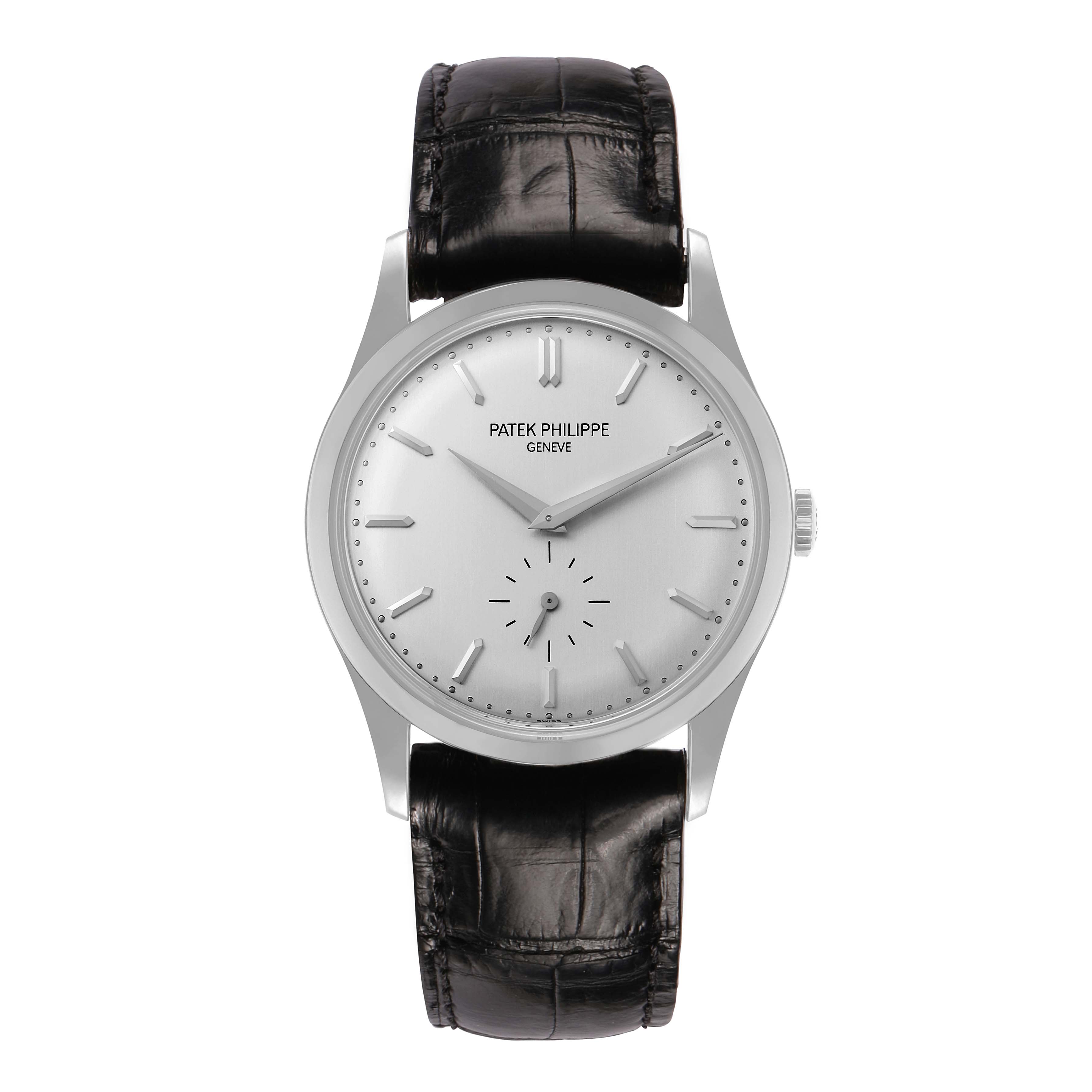 The Patek Philippe Calatrava 5196 Men
s White Gold Silver Dial watch is shown from a top-down angle, highlighting the dial, hands, and leather strap.