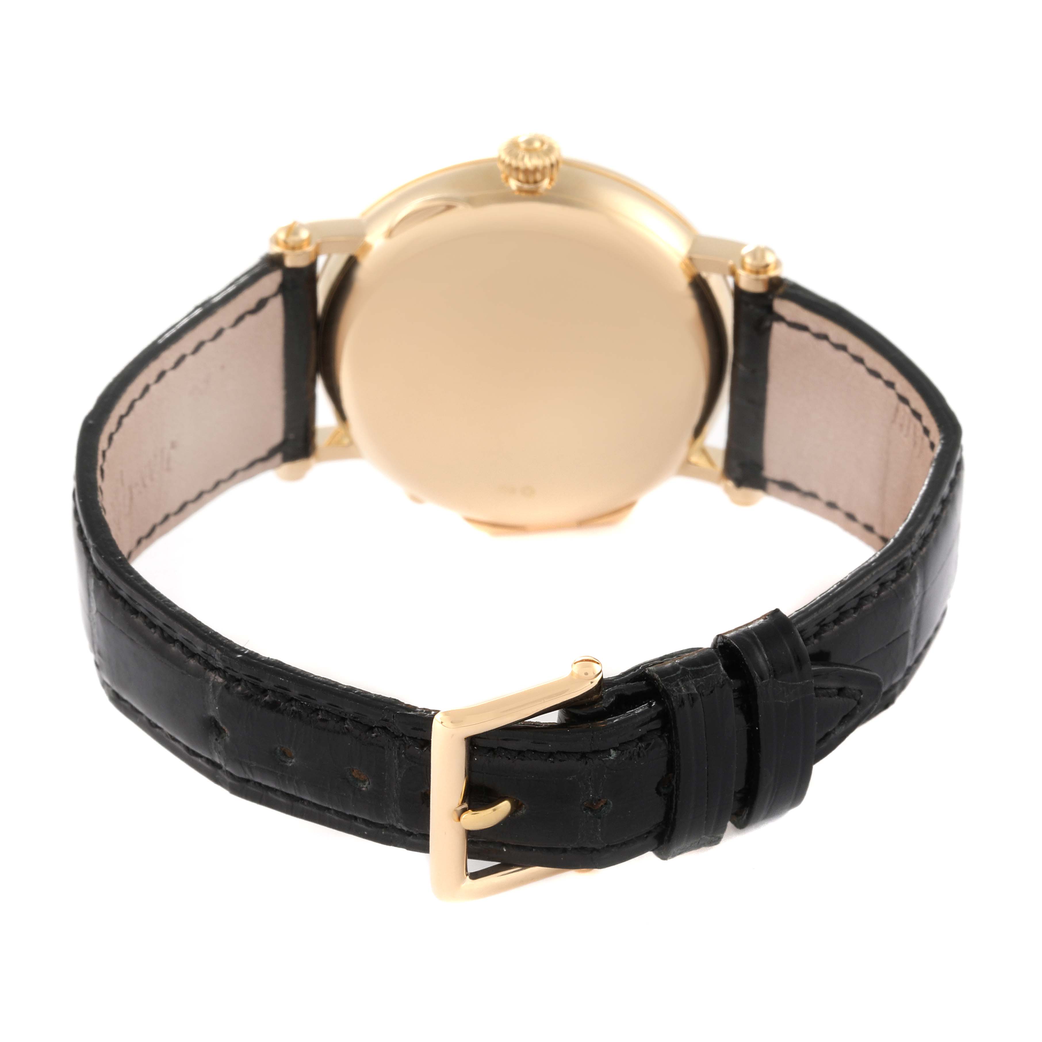 The image shows the back view of a Patek Philippe Calatrava 5015J-001 Men
s Yellow Gold White Dial 5015J-001 Men
s Yellow Gold White Dial watch with its leather strap and clasp visible.