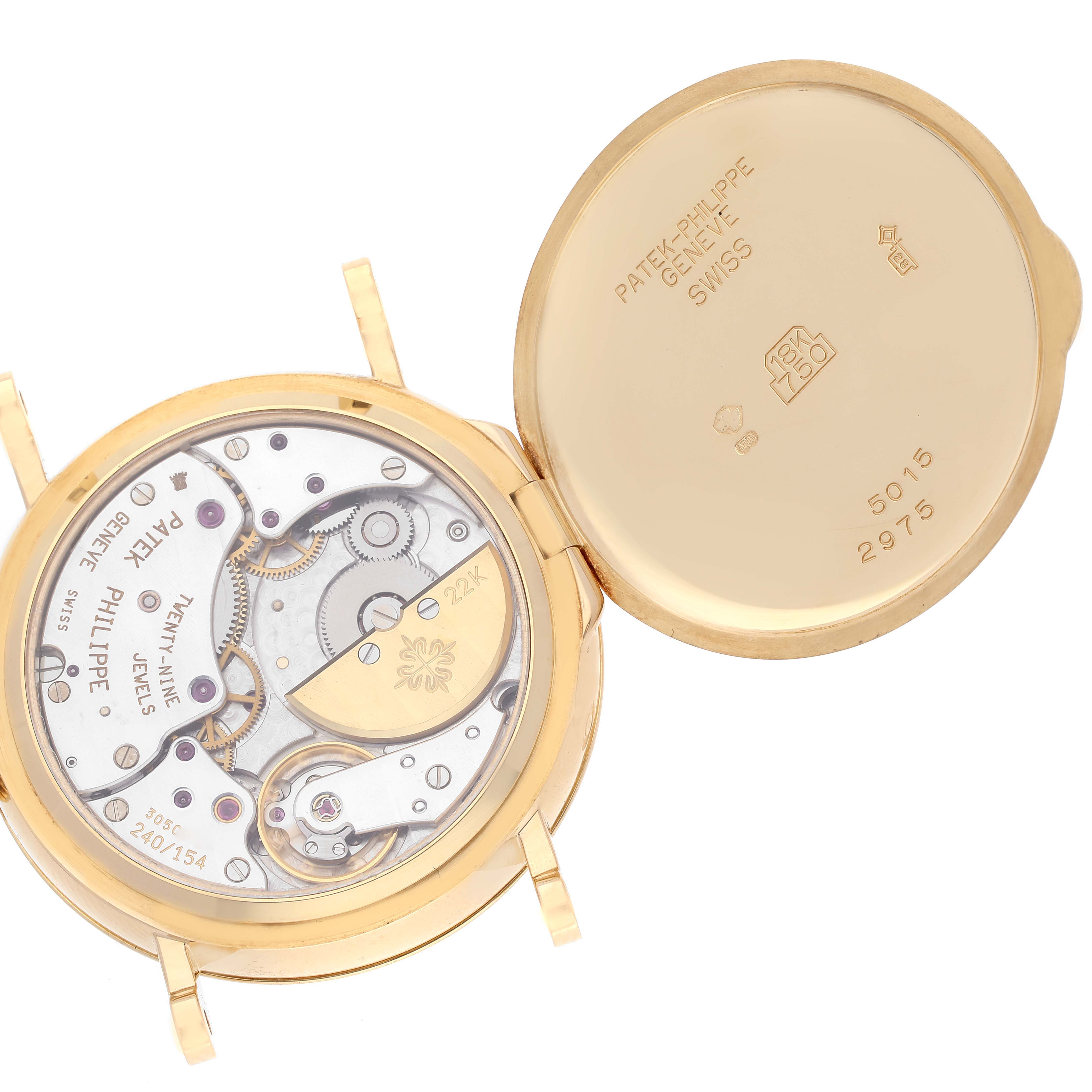 The image shows the open case back of the Patek Philippe Calatrava 5015J-001 Men
s Yellow Gold White Dial 5015J-001 Men
s Yellow Gold White Dial watch, revealing the movement and inner case details.