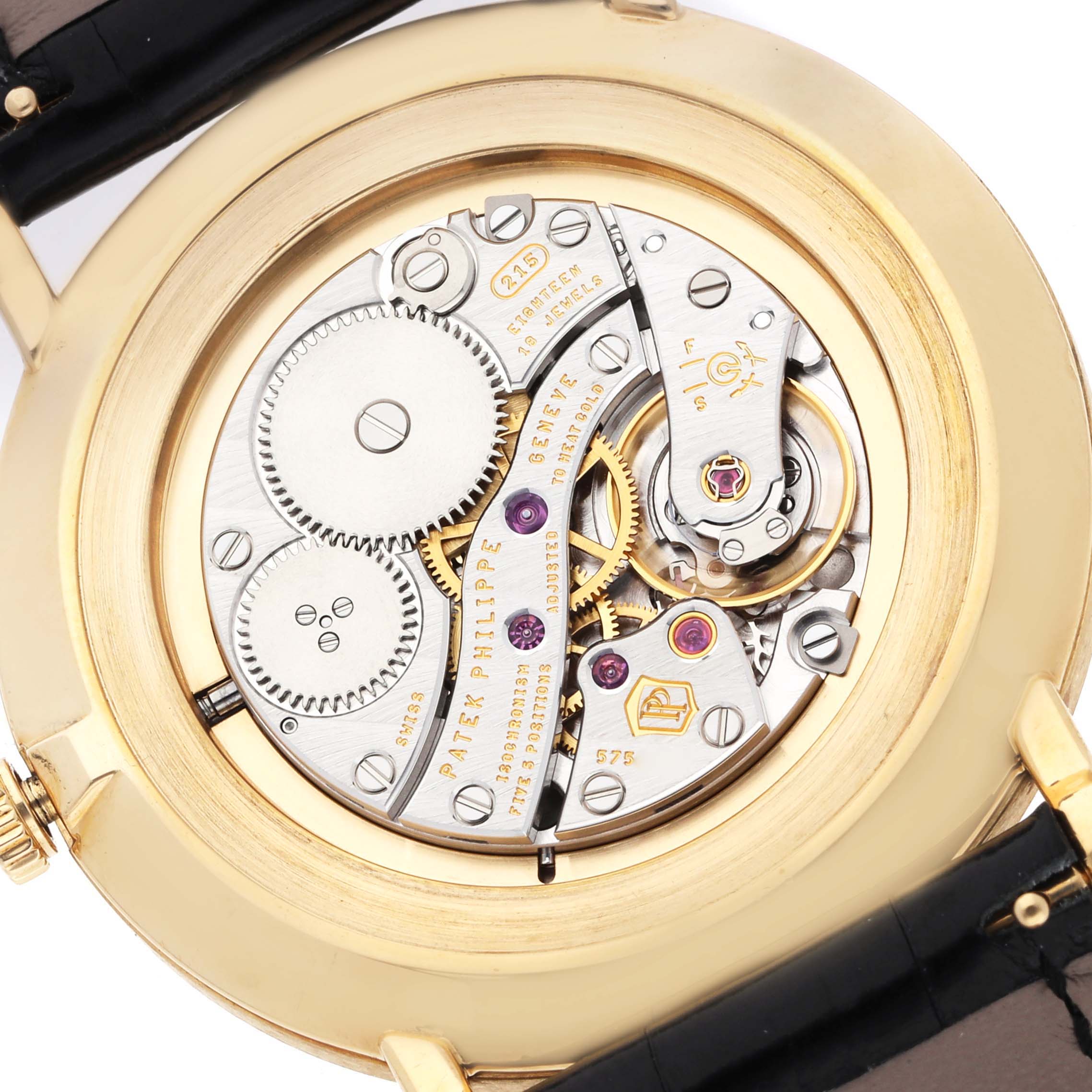 The image shows the back of a Patek Philippe Calatrava 5119 Men
s Yellow Gold White Dial watch, highlighting its internal mechanical movement.