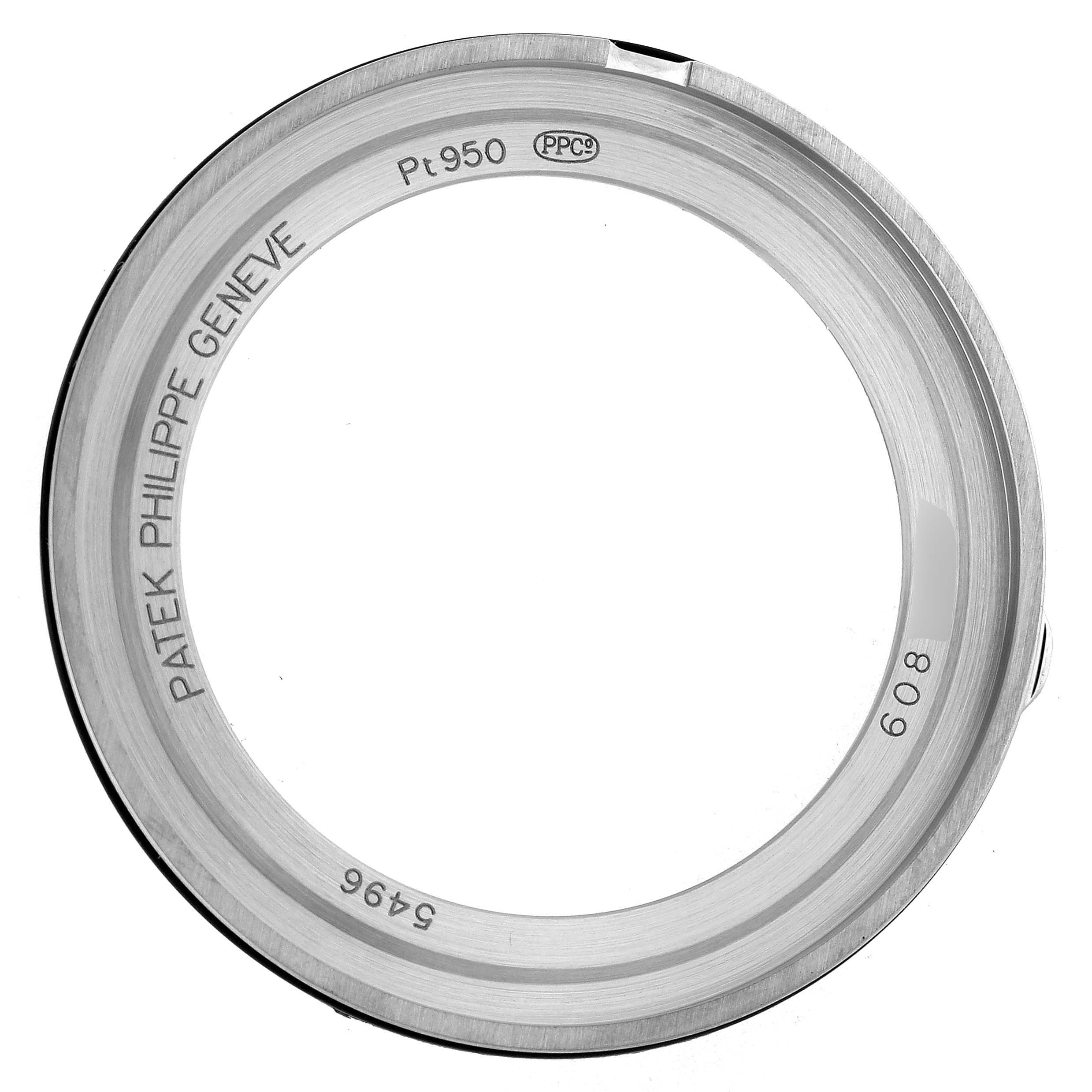 The image shows the bezel of a Patek Philippe Complications 5496P-014 Men's Platinum Brown Dial watch from a top-down angle, highlighting its engraved details.