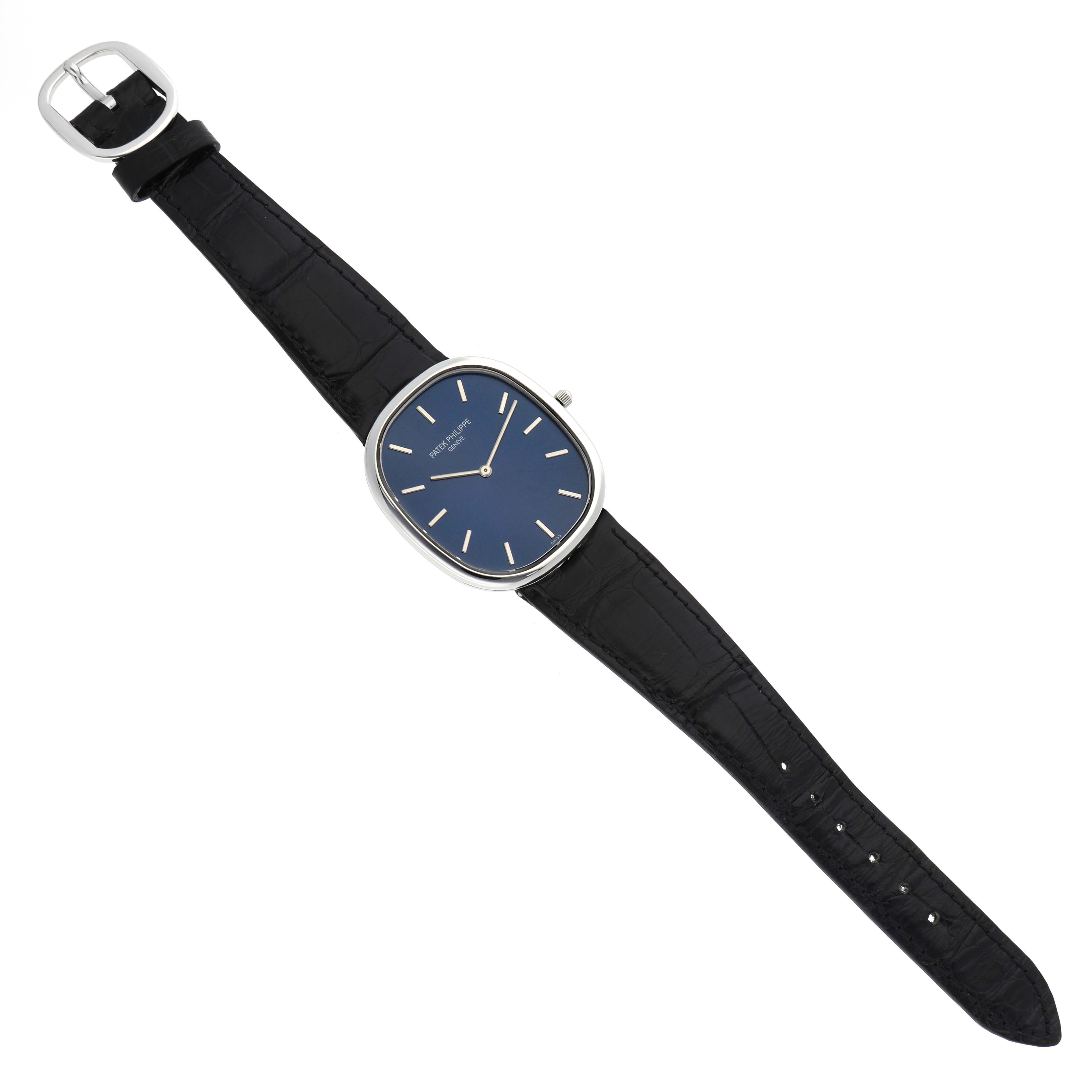 The Patek Philippe Golden Ellipse 5738P-001 Men's Platinum Blue Dial watch is shown from a top-down angle, displaying the face, hands, and leather strap.