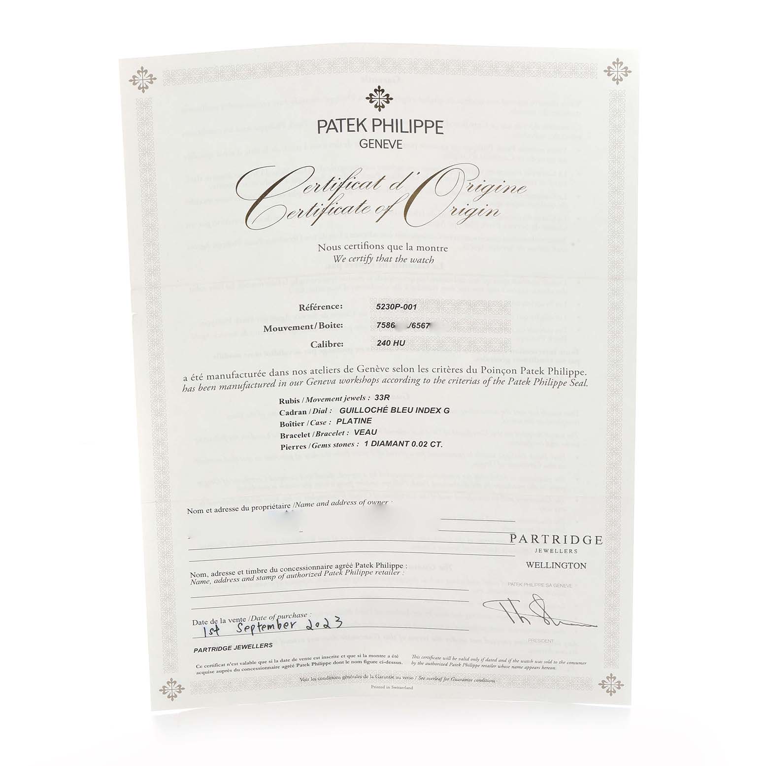 The image shows a Certificate of Origin for the Patek Philippe Complications 5230P-001 Men's Platinum Blue Dial model, featuring detailed specifications and authenticity.