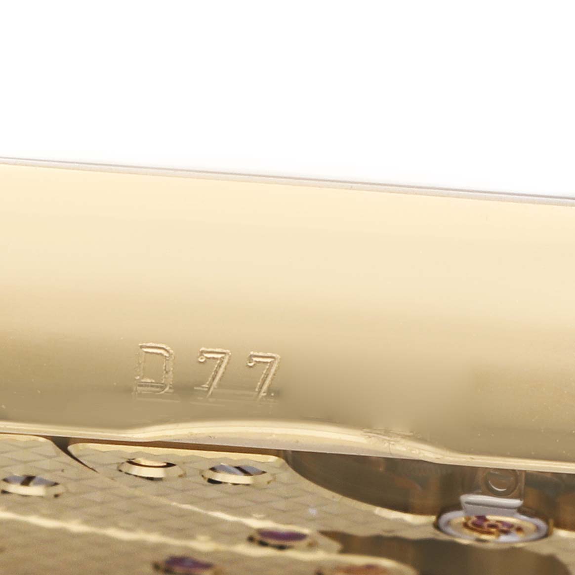 The image shows a close-up of the movement with engravings on a Rolex Cellini 5440 Men's Yellow Gold Champagne Dial watch.