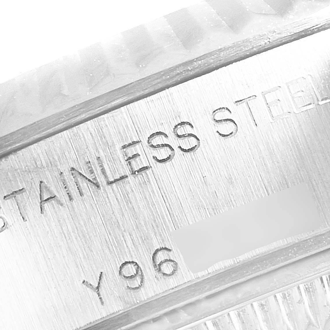 The image shows a close-up of the stainless steel casing of a Rolex Datejust 79174 Women's Stainless Steel Pink Dial 79174 Women's Stainless Steel Pink Dial watch, including part of its serial number.