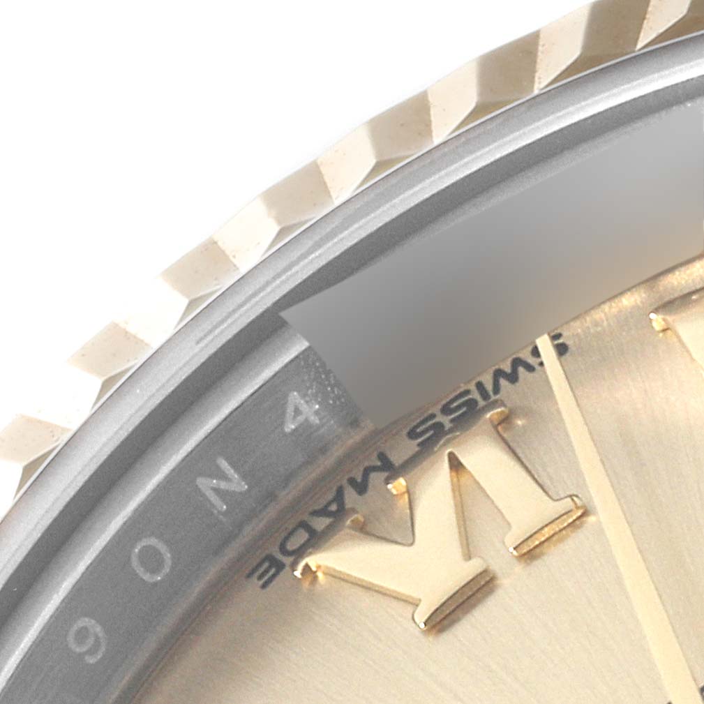 This close-up image of a Rolex Datejust 279173 Women's Steel and Gold (two tone) Champagne Dial 279173 Women's Steel and Gold (two tone) Champagne Dial watch shows part of the bezel, dial, and "Swiss Made" text.