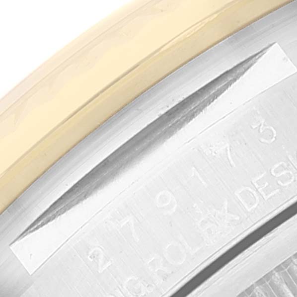 This close-up image displays part of the engraved case back of a Rolex Datejust 279173 Women's Steel and Gold (two tone) Champagne Dial 279173 Women's Steel and Gold (two tone) Champagne Dial watch, showing stainless steel and gold elements.