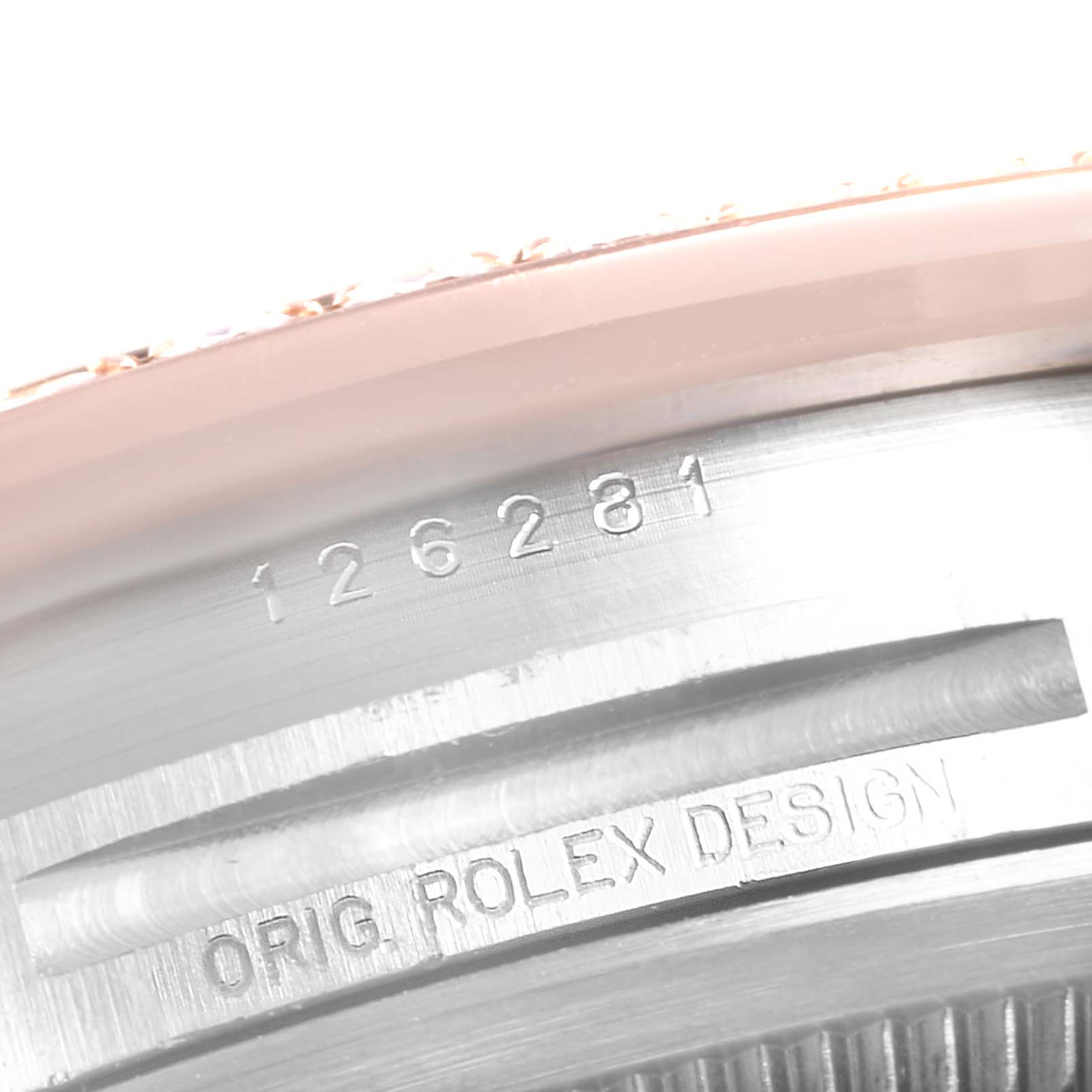 The image shows a close-up angle of part of the casing with engravings on a Rolex Datejust 126281 Men's Steel and Gold (two tone) Pink Dial 126281 Men's Steel and Gold (two tone) Pink Dial model.