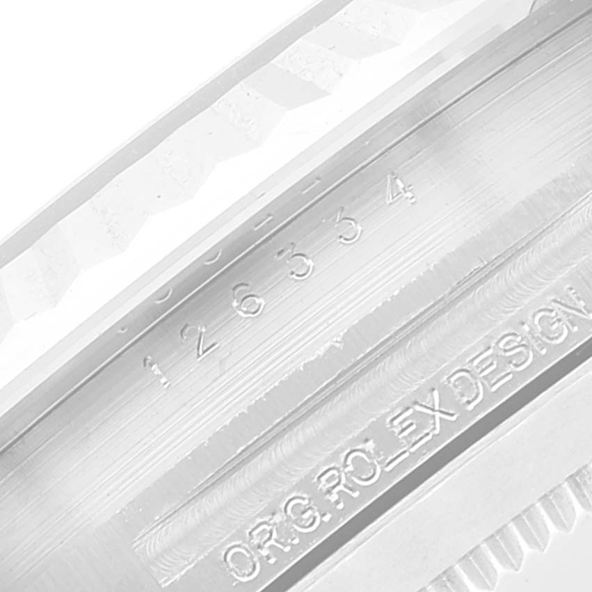 This image shows a close-up angle of the inner bezel of the Rolex Datejust 41 126334 Men's Stainless Steel Blue Dial 126334 Men's Stainless Steel Blue Dial model, displaying the serial number and engraving.