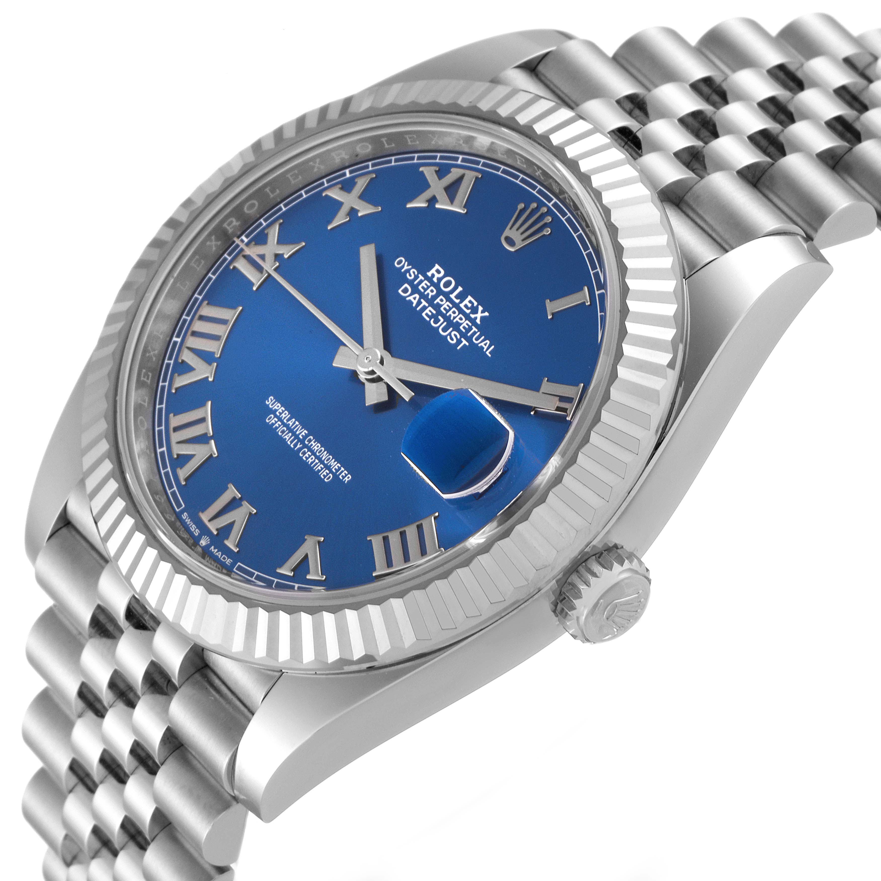 The image shows a Rolex Datejust 41 126334 Men
s Stainless Steel Blue Dial 126334 Men
s Stainless Steel Blue Dial watch at an angled side view, highlighting its blue dial, Roman numerals, fluted bezel, and Jubilee bracelet.