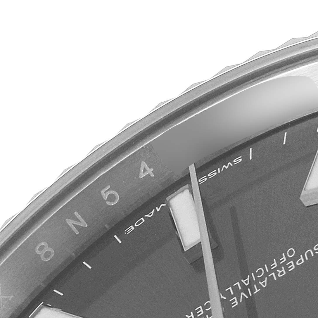 This close-up image of the Rolex Datejust 41 126334 Men
s Stainless Steel Grey Dial 126334 Men
s Stainless Steel Grey Dial watch shows part of the bezel, the number indicators, and the edge of the dial.