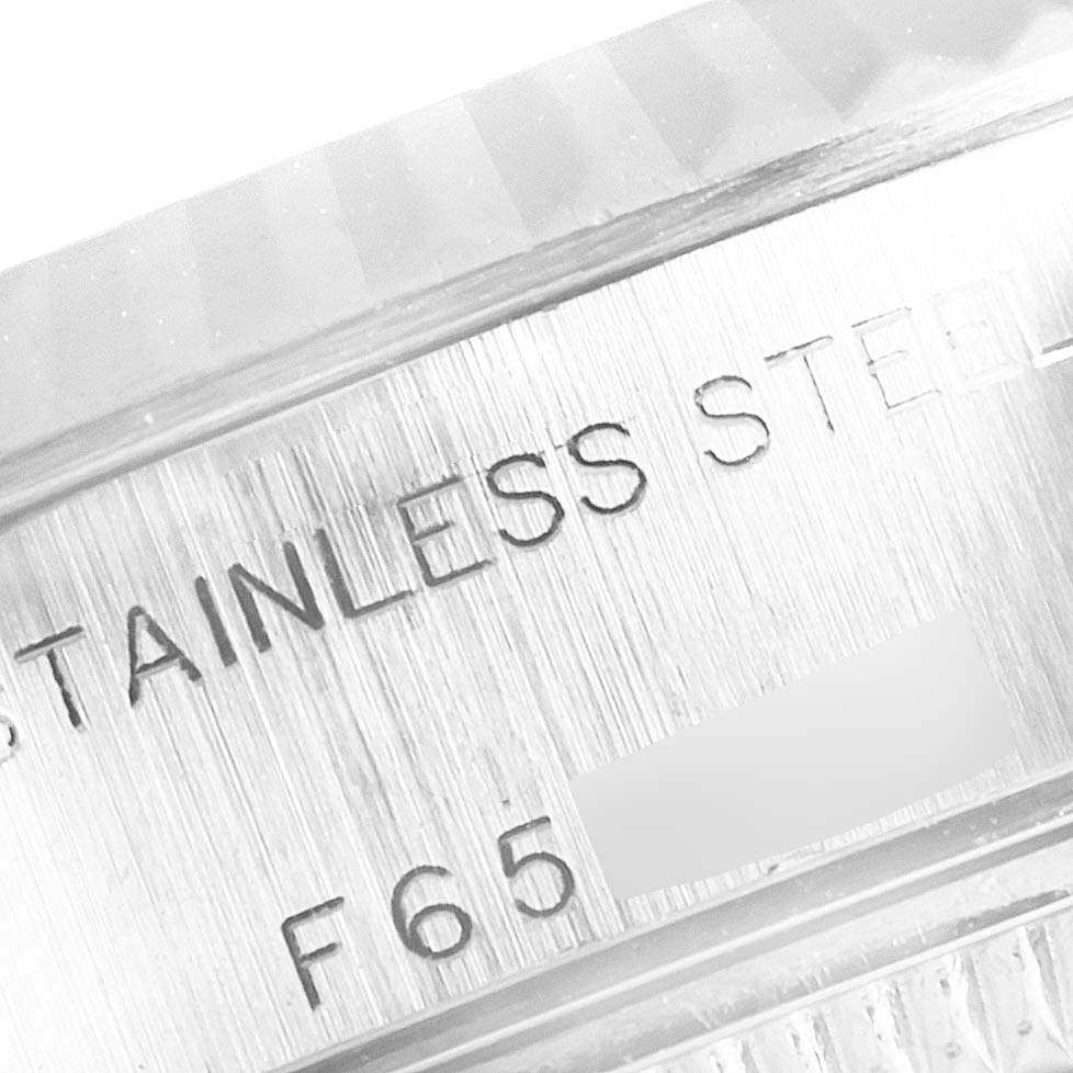This image shows a close-up of the inner case engraving on a Rolex Datejust 79174 Women's Stainless Steel White Dial 79174 Women's Stainless Steel White Dial, highlighting the "Stainless Steel" and serial number.