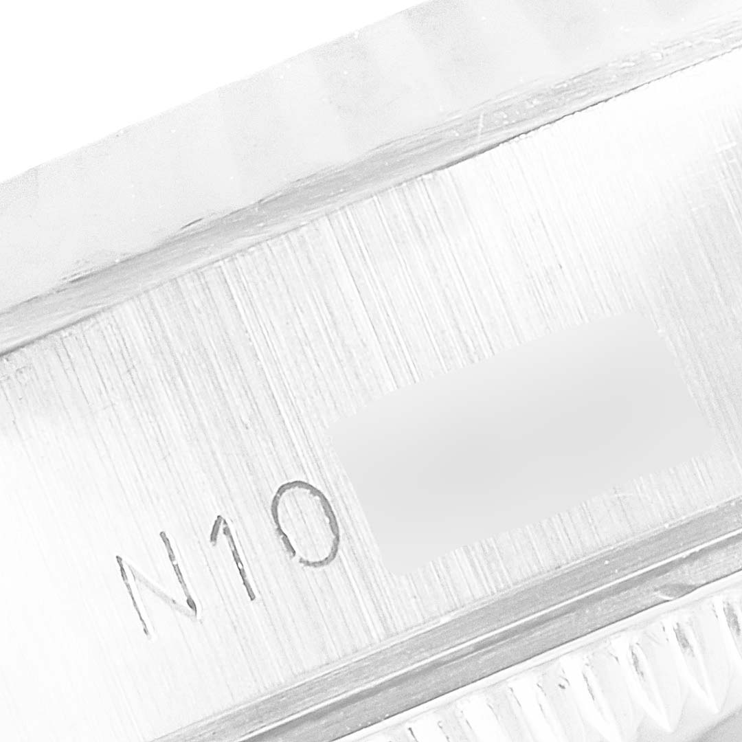 This close-up image shows the serial number engraving on the side of the Rolex Datejust 69174 Women's Stainless Steel Silver Dial 69174 Women's Stainless Steel Silver Dial watch's case.