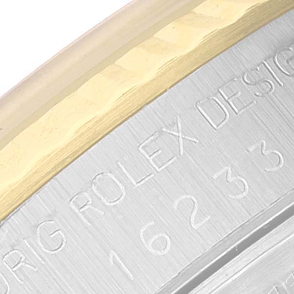 The image shows a close-up of the engraved case back and fluted bezel of a Rolex Datejust 16233 Men's Steel and Gold (two tone) Champagne Dial 16233 Men's Steel and Gold (two tone) Champagne Dial watch.