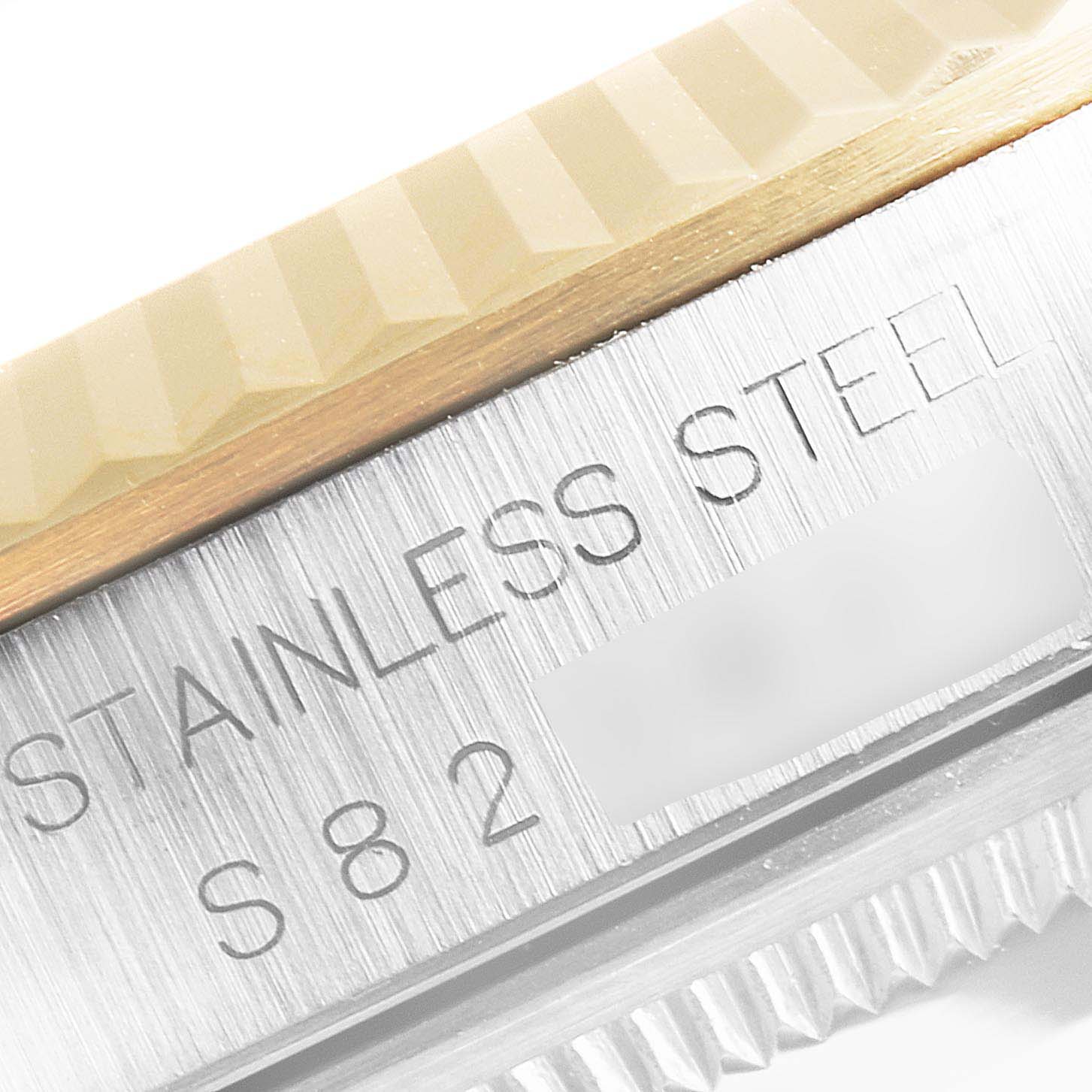 This image shows a close-up of the stainless steel side and fluted bezel of a Rolex Datejust 16233 Men's Steel and Gold (two tone) Champagne Dial 16233 Men's Steel and Gold (two tone) Champagne Dial watch.