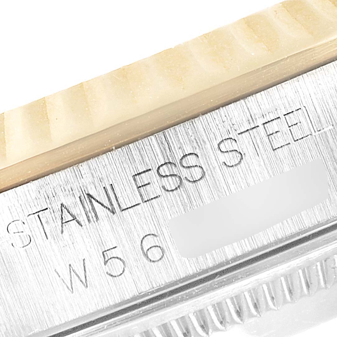 The image shows a close-up of the side of a Rolex Datejust 16233 Men
s Steel and Gold (two tone) Grey Dial 16233 Men
s Steel and Gold (two tone) Grey Dial watch, focusing on the stainless steel part and its engraved text.